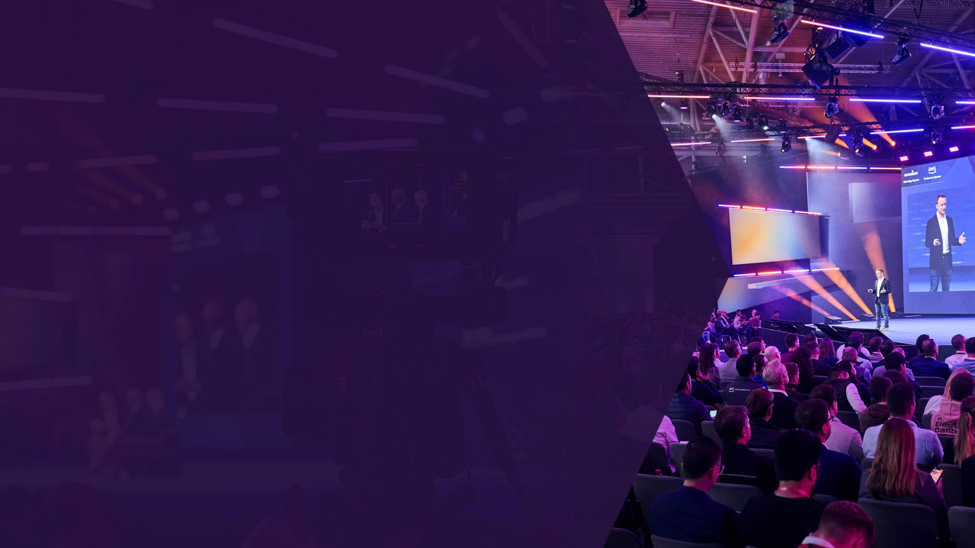 Speaker on stage at a tech conference with a large seated audience and colorful lighting.