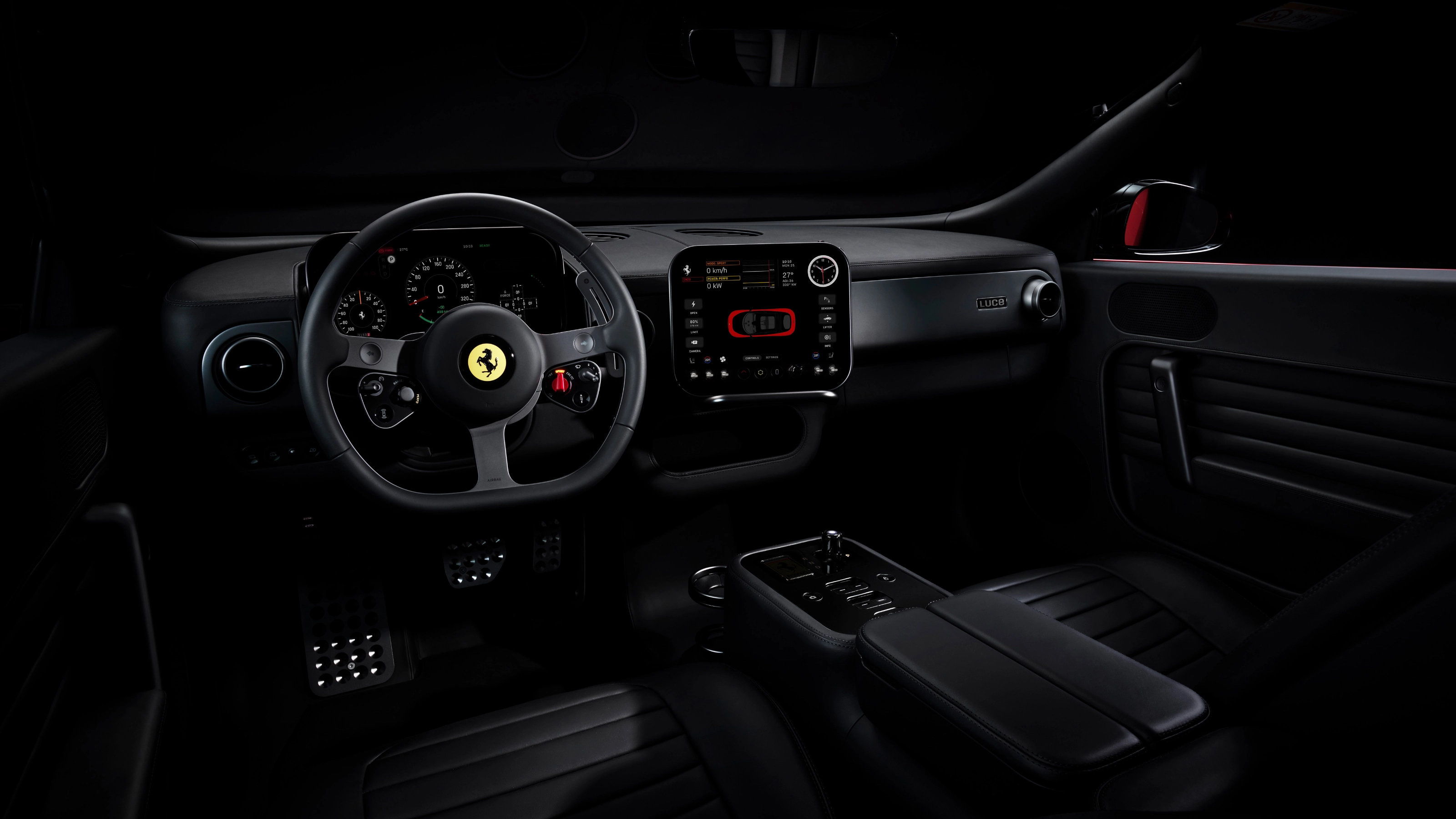 Dark Ferrari interior with illuminated dashboard and steering wheel.