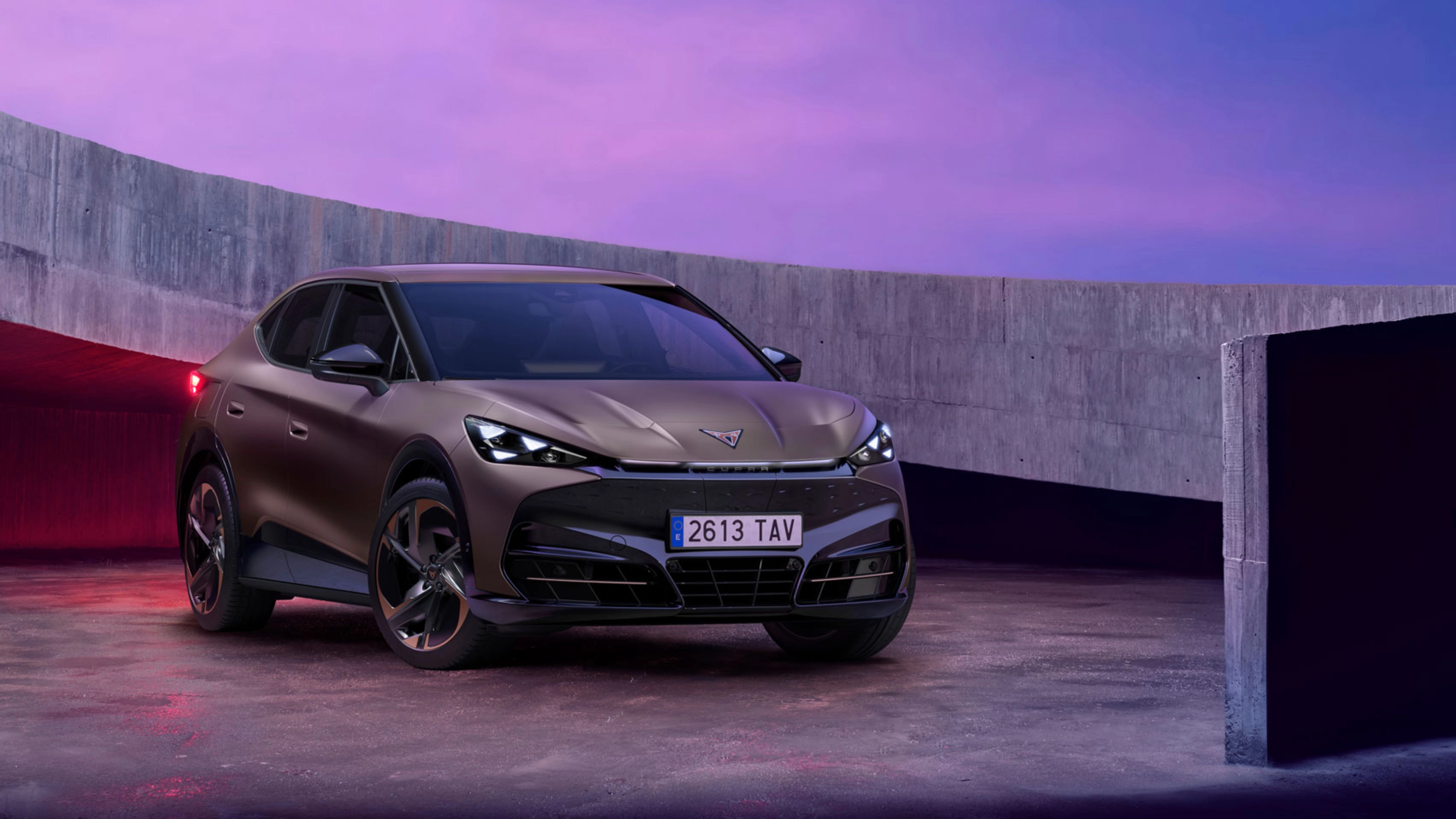 Cupra car parked in modern concrete setting with purple lighting.