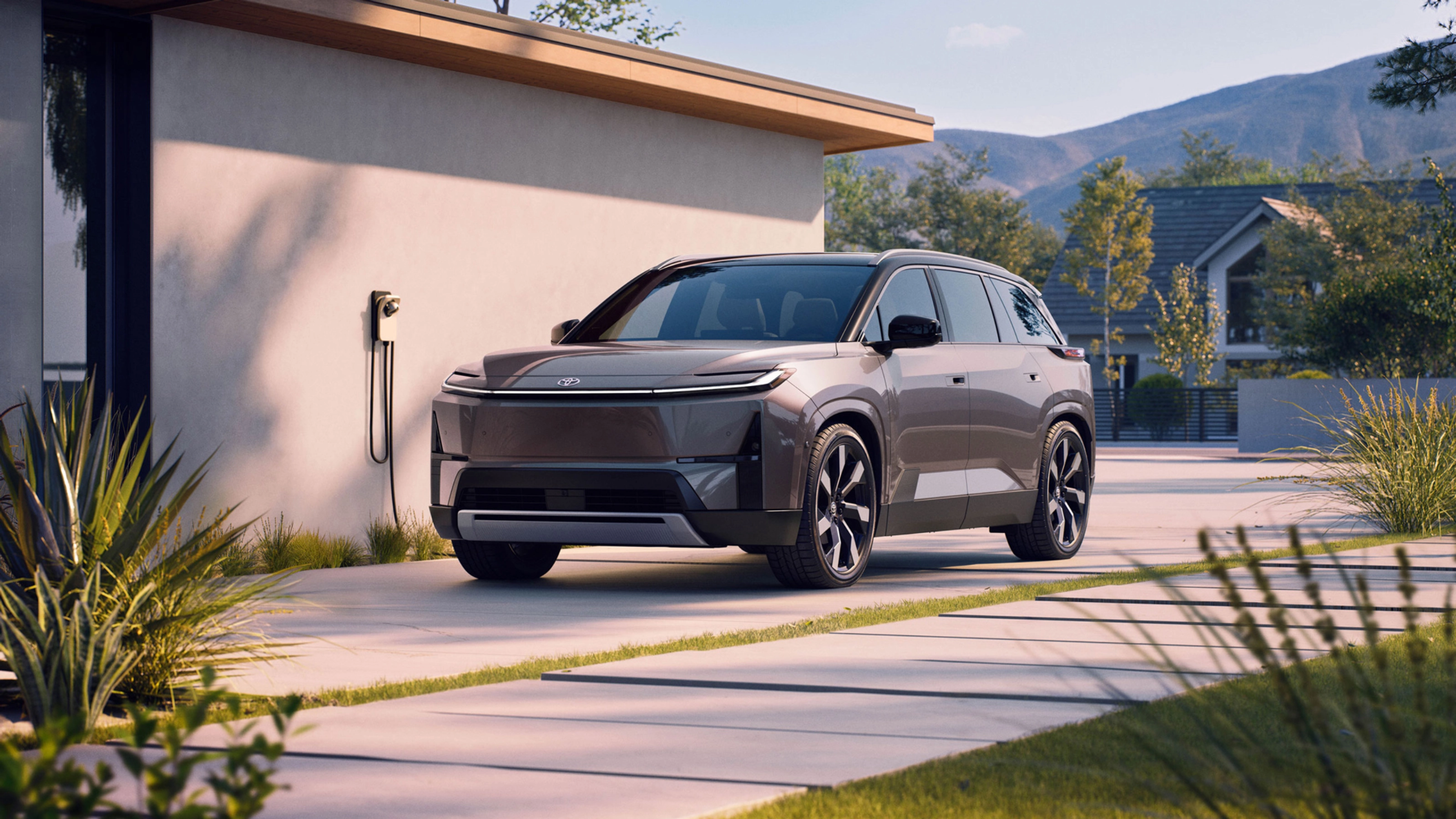 Electric SUV parked at home charging station.