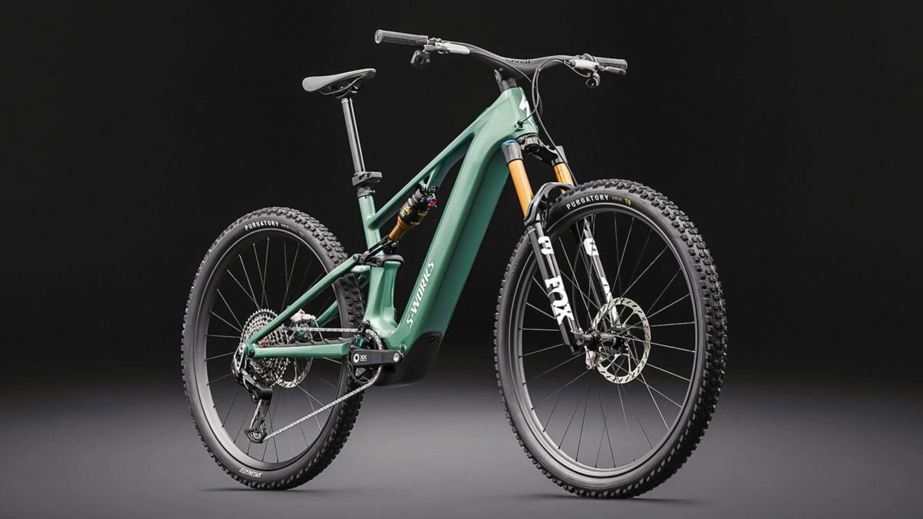 Green full-suspension mountain bike on a dark background.