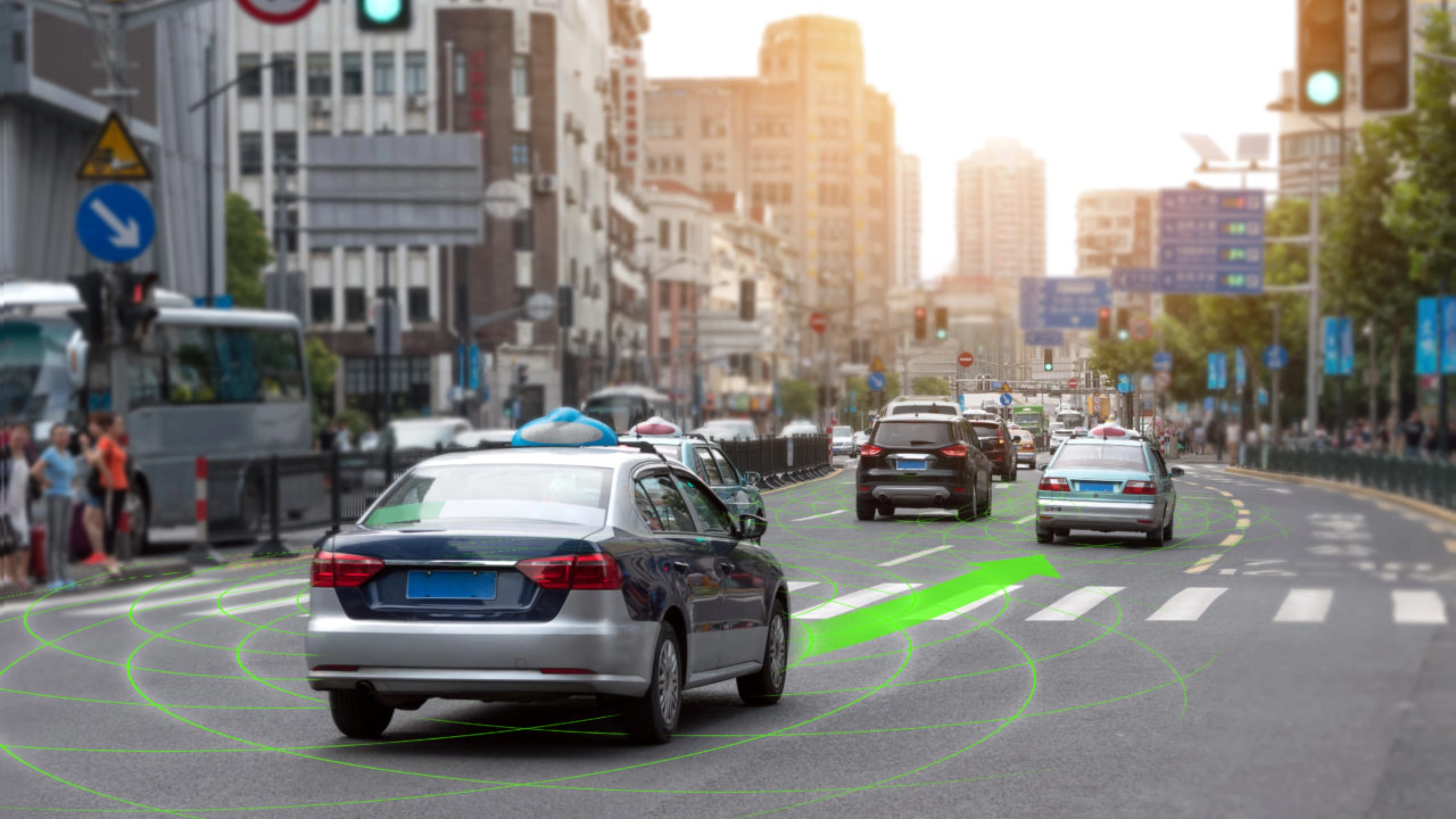 Car driving through a city street with lane guidance highlighted by driver assistance.