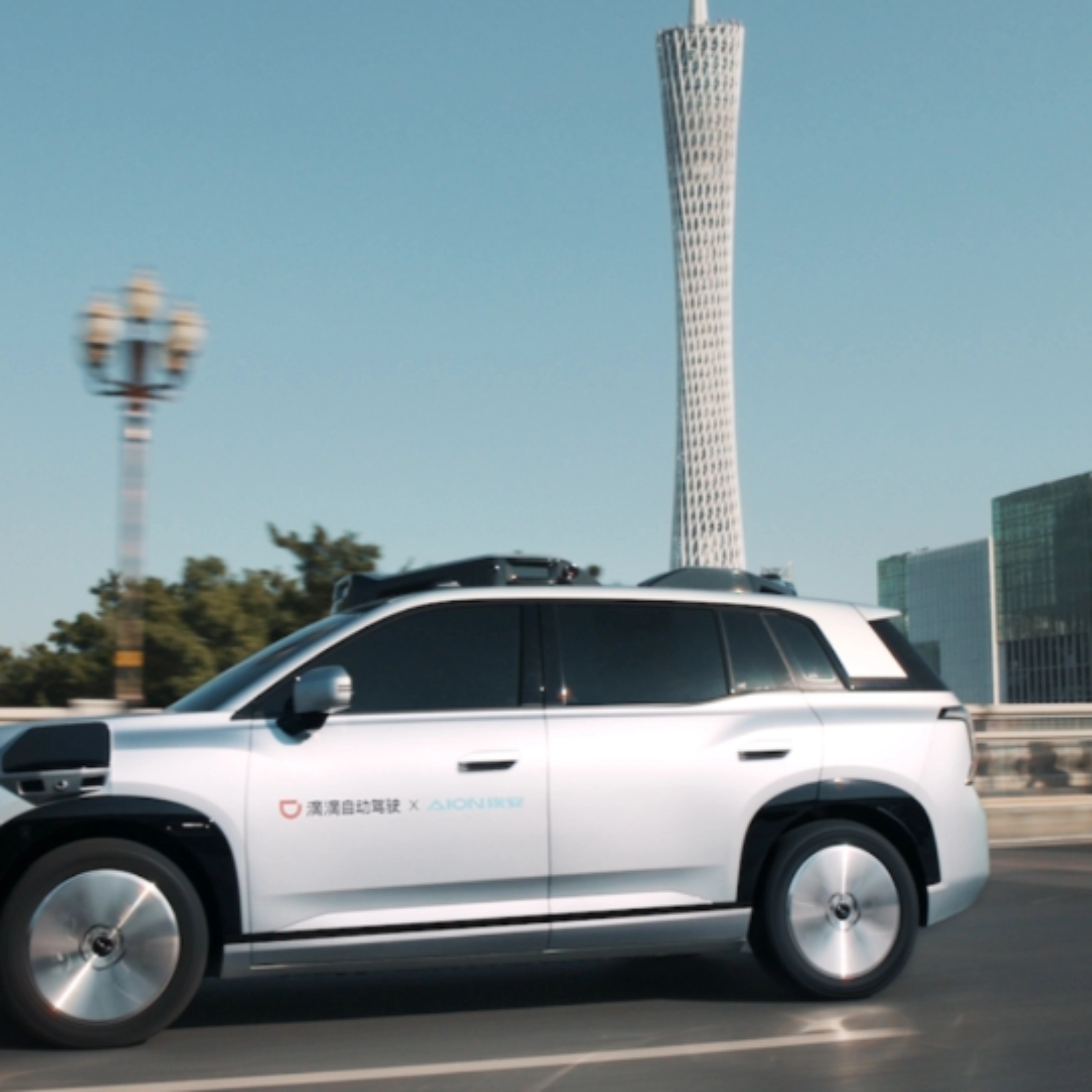 Ein autonomes SUV fährt durch eine Stadt mit modernen Gebäuden im Hintergrund.