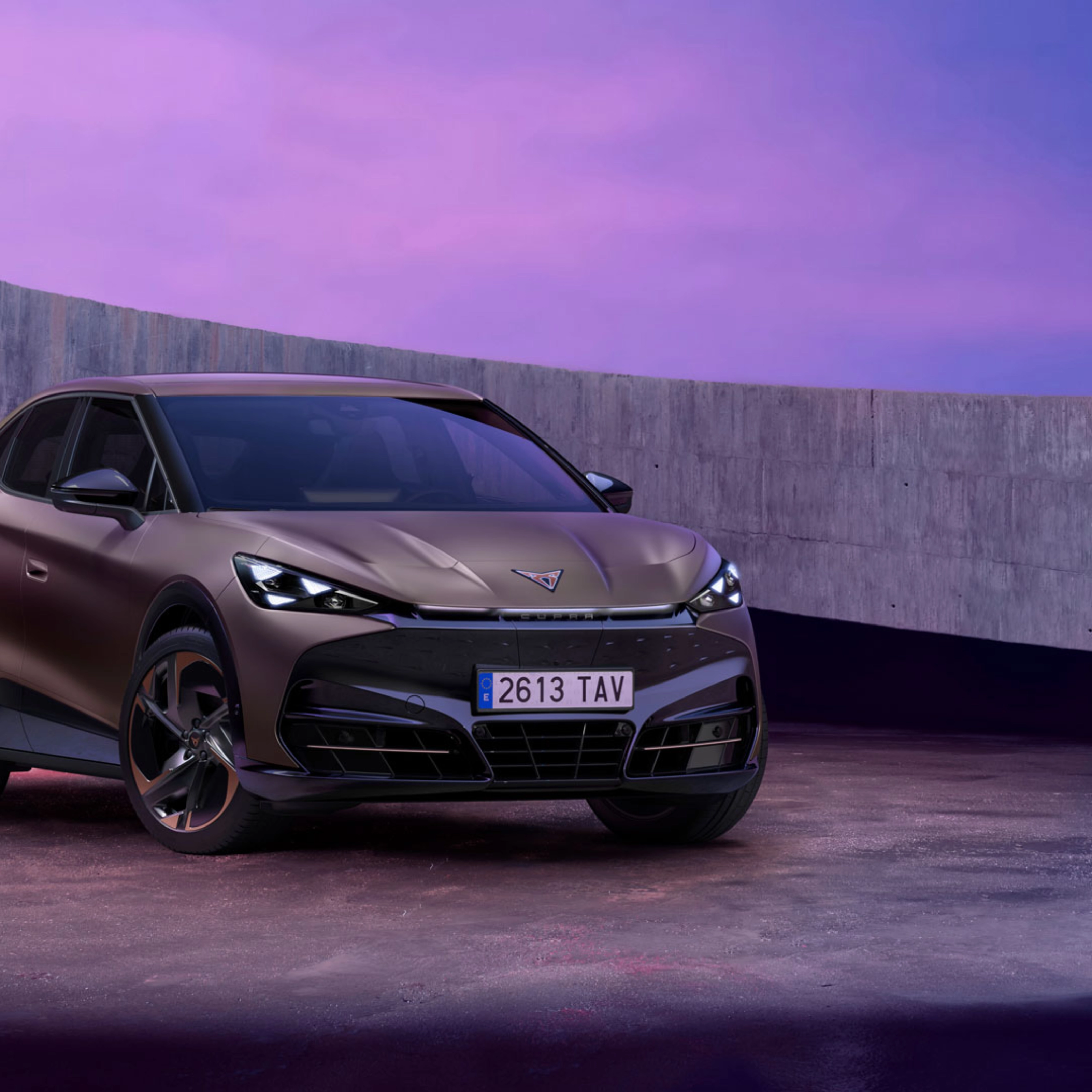 Cupra car parked in modern concrete setting with purple lighting.