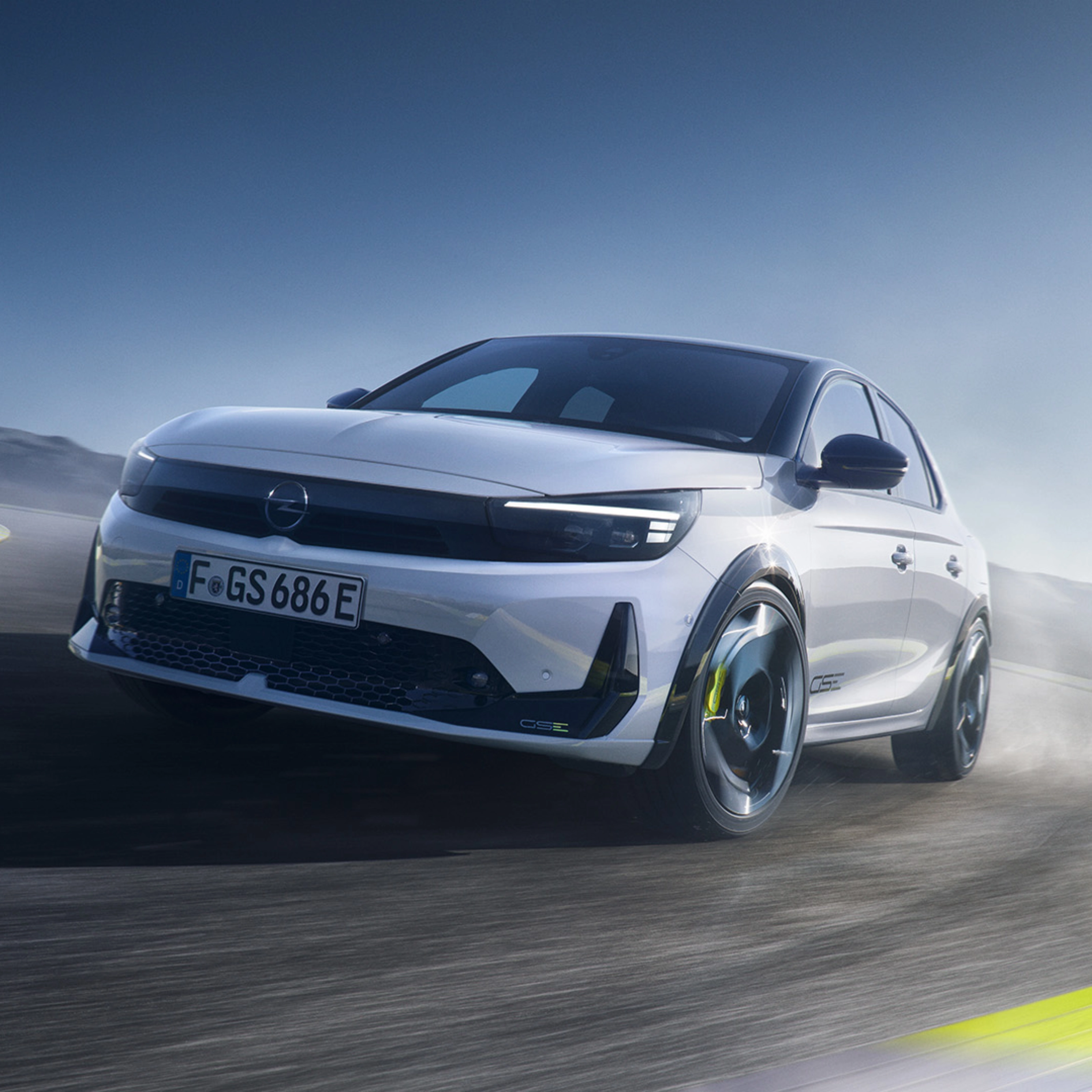 Opel GS Elektroauto fährt schnell in einer Kurve auf einer Rennstrecke.