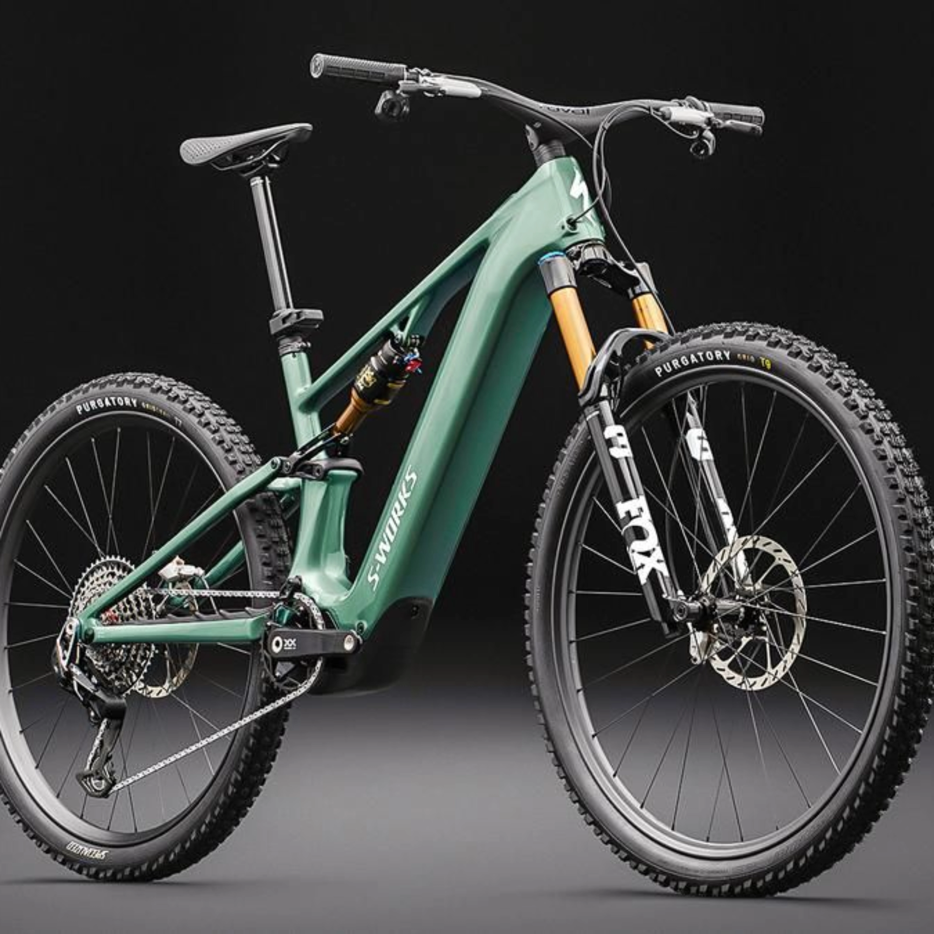 Green full-suspension mountain bike on a dark background.
