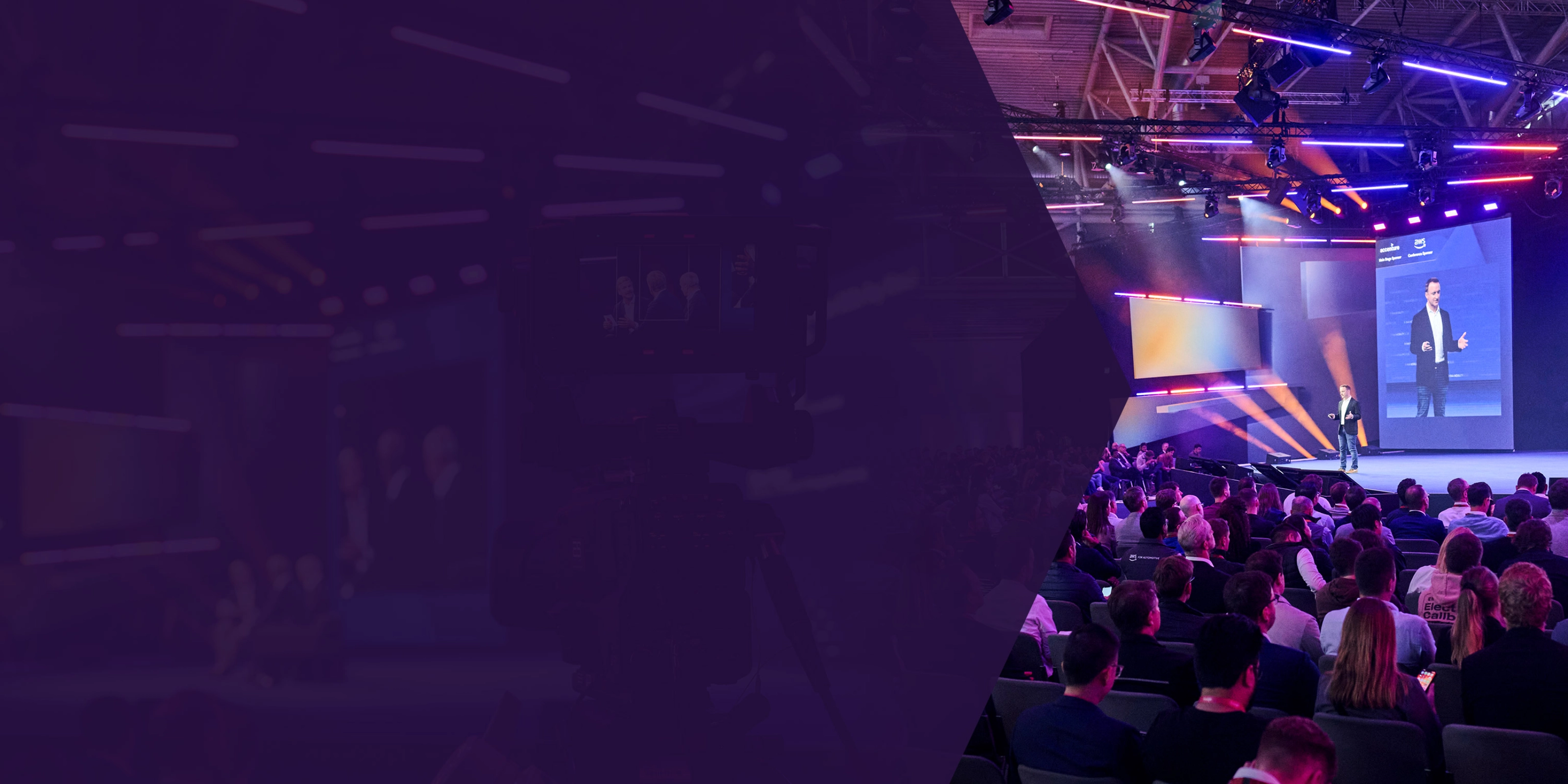 Speaker on stage at a tech conference with a large seated audience and colorful lighting.