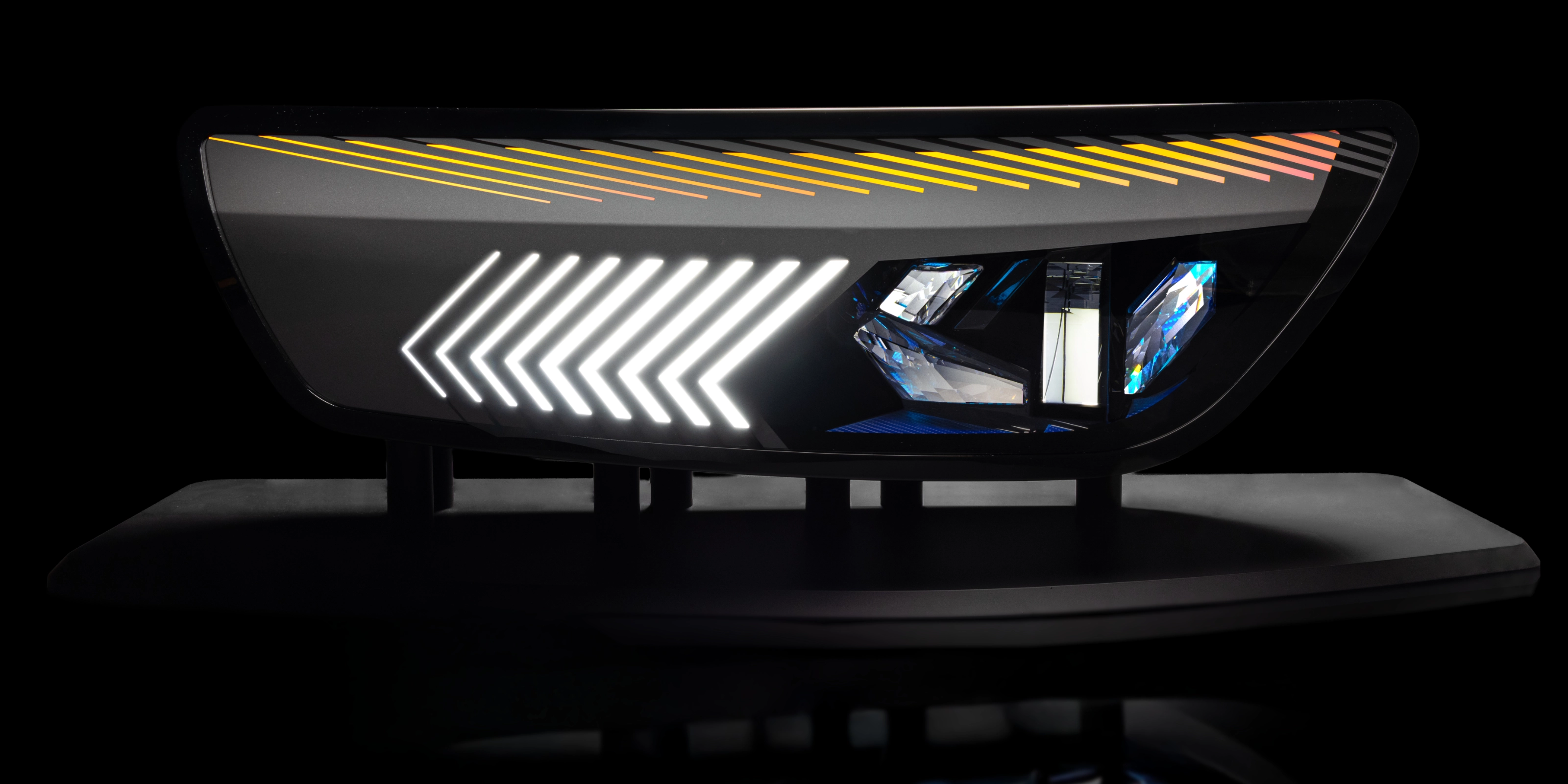 Close-up of a modern car tail light with animated red and yellow LED patterns.