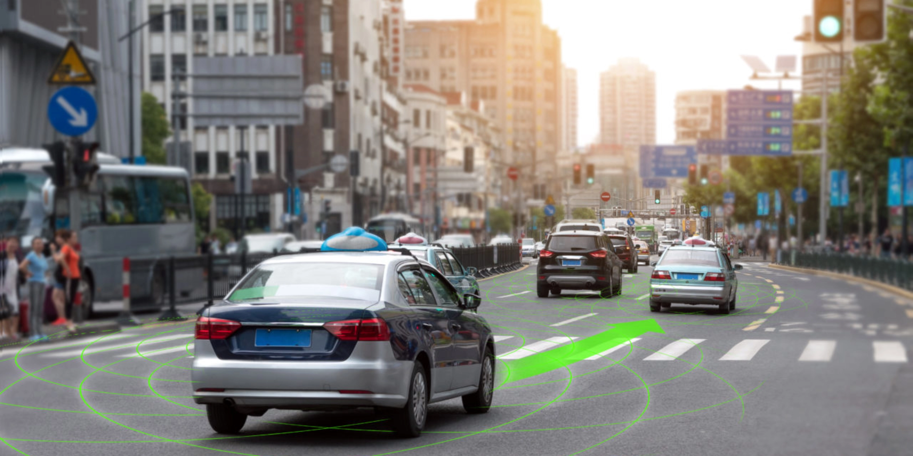 Car driving through a city street with lane guidance highlighted by driver assistance.