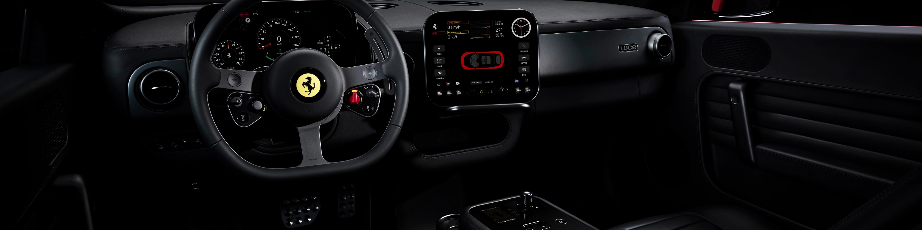 Dark Ferrari interior with illuminated dashboard and steering wheel.