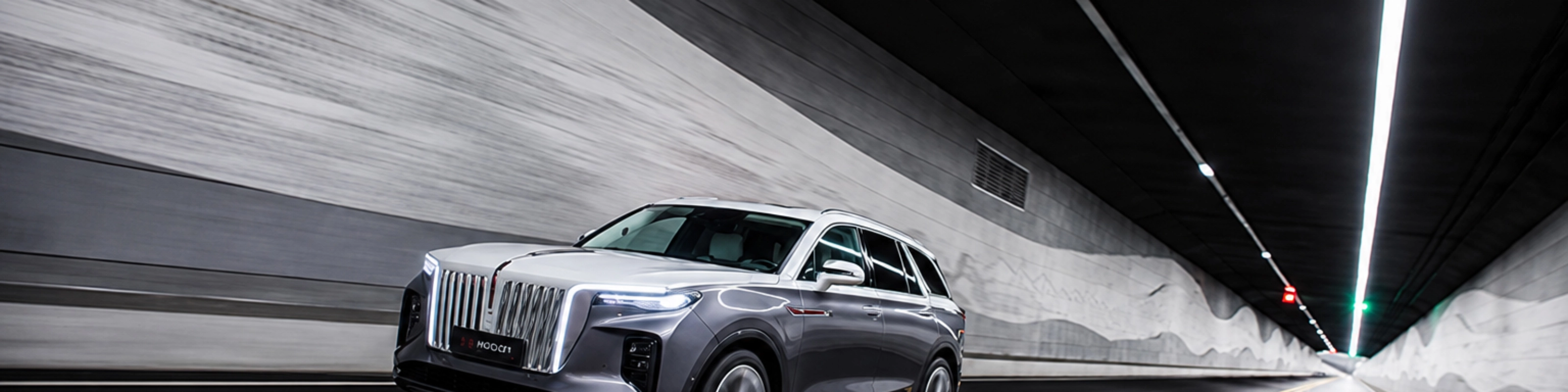 Hongqi SUV driving through a road tunnel.