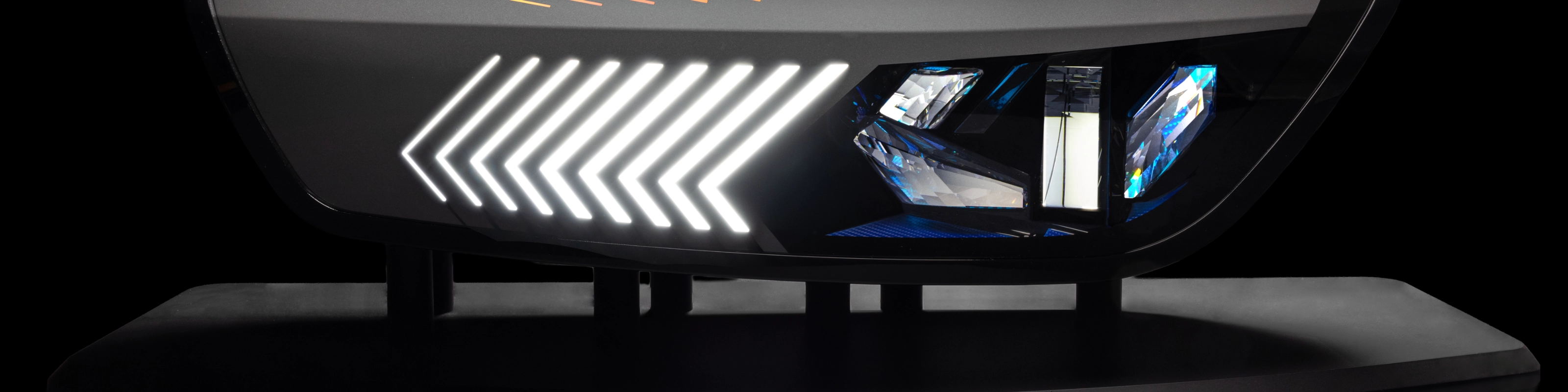 Close-up of a modern car tail light with animated red and yellow LED patterns.
