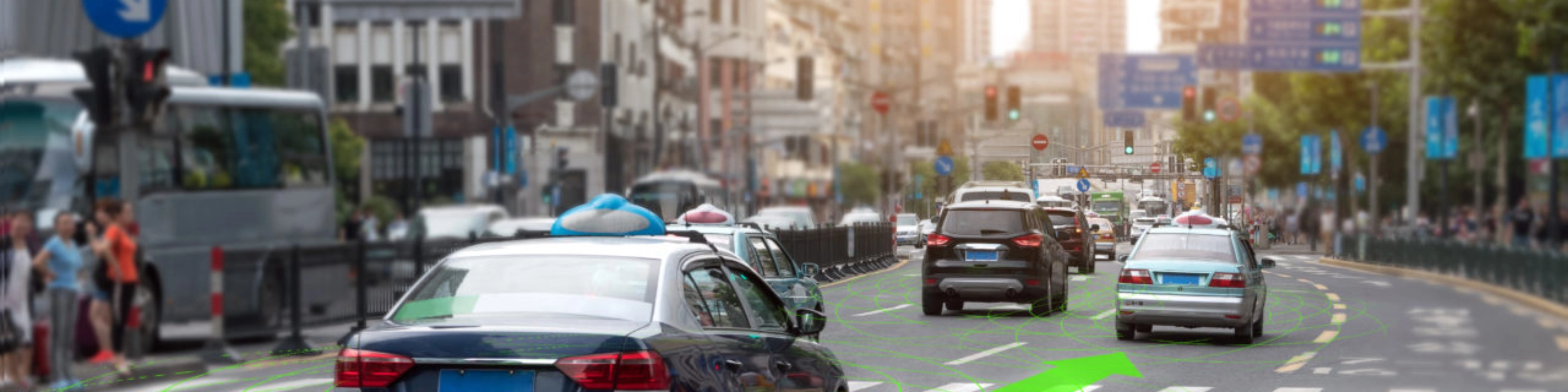 Car driving through a city street with lane guidance highlighted by driver assistance.