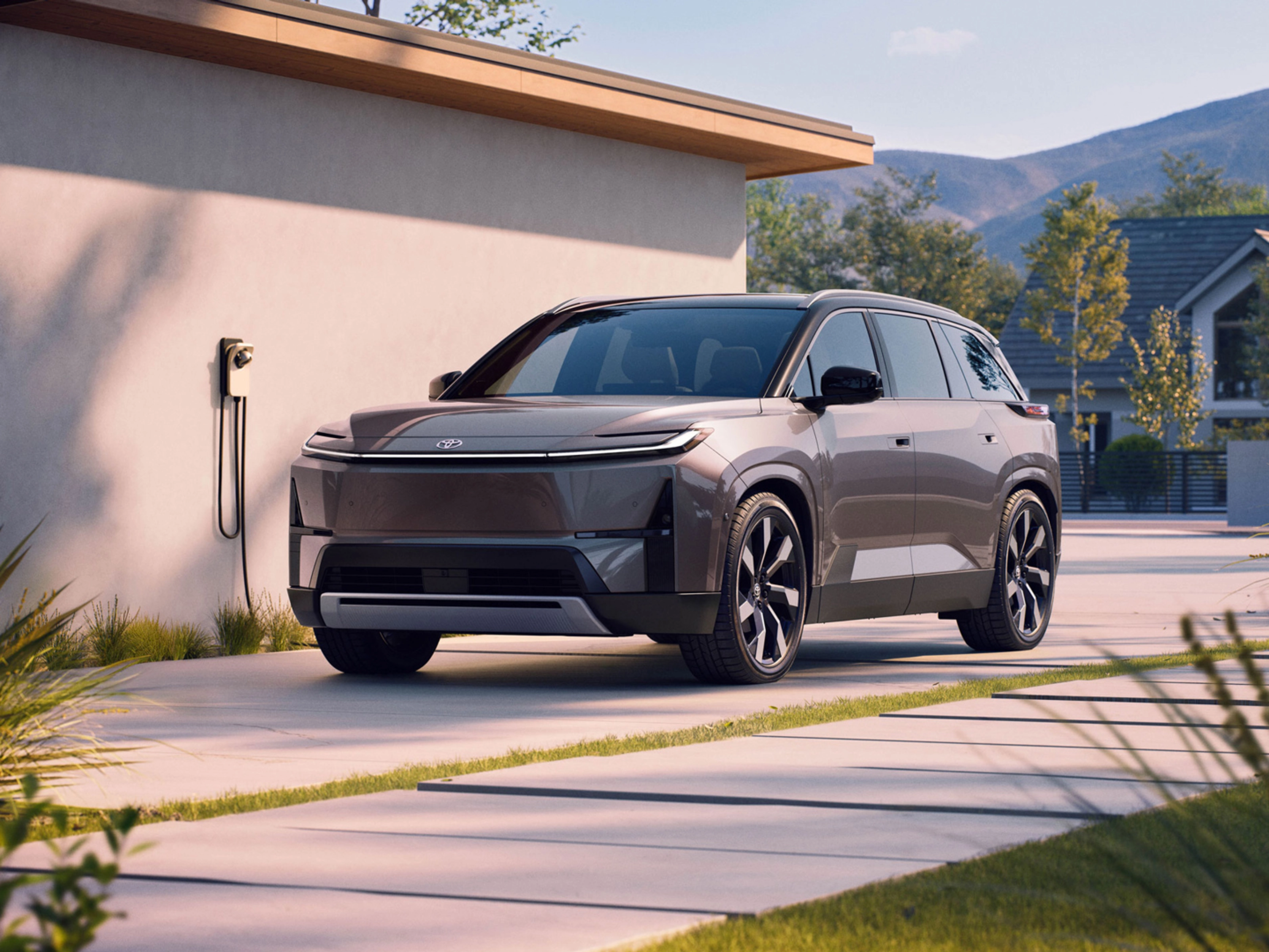 Electric SUV parked at home charging station.