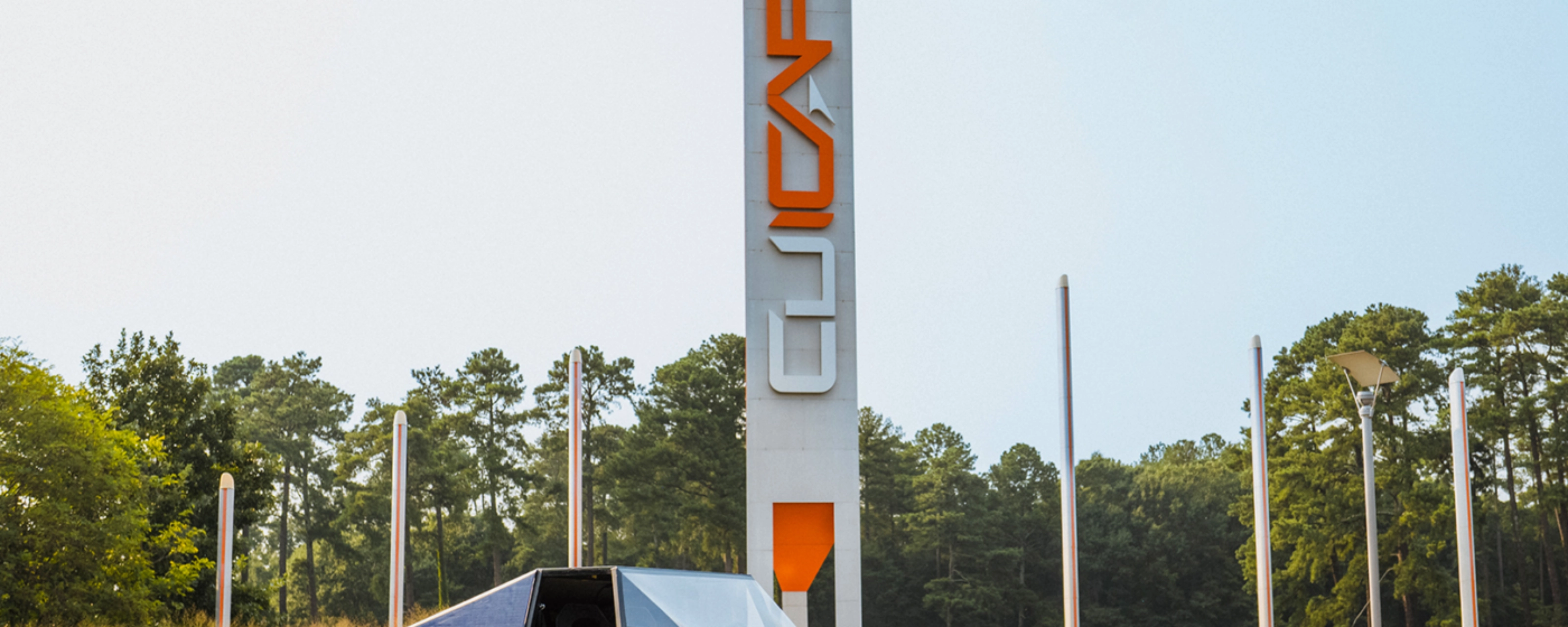 Autonomous vehicle beside a CU-ICAR test tower at Clemson University.
