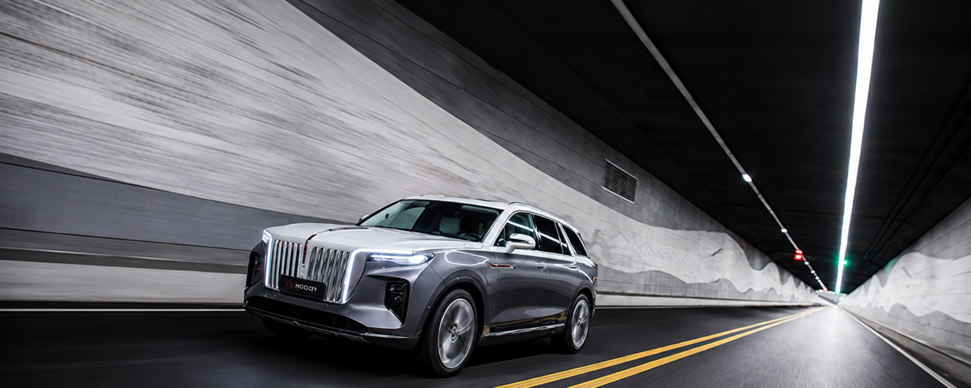 Hongqi SUV driving through a road tunnel.