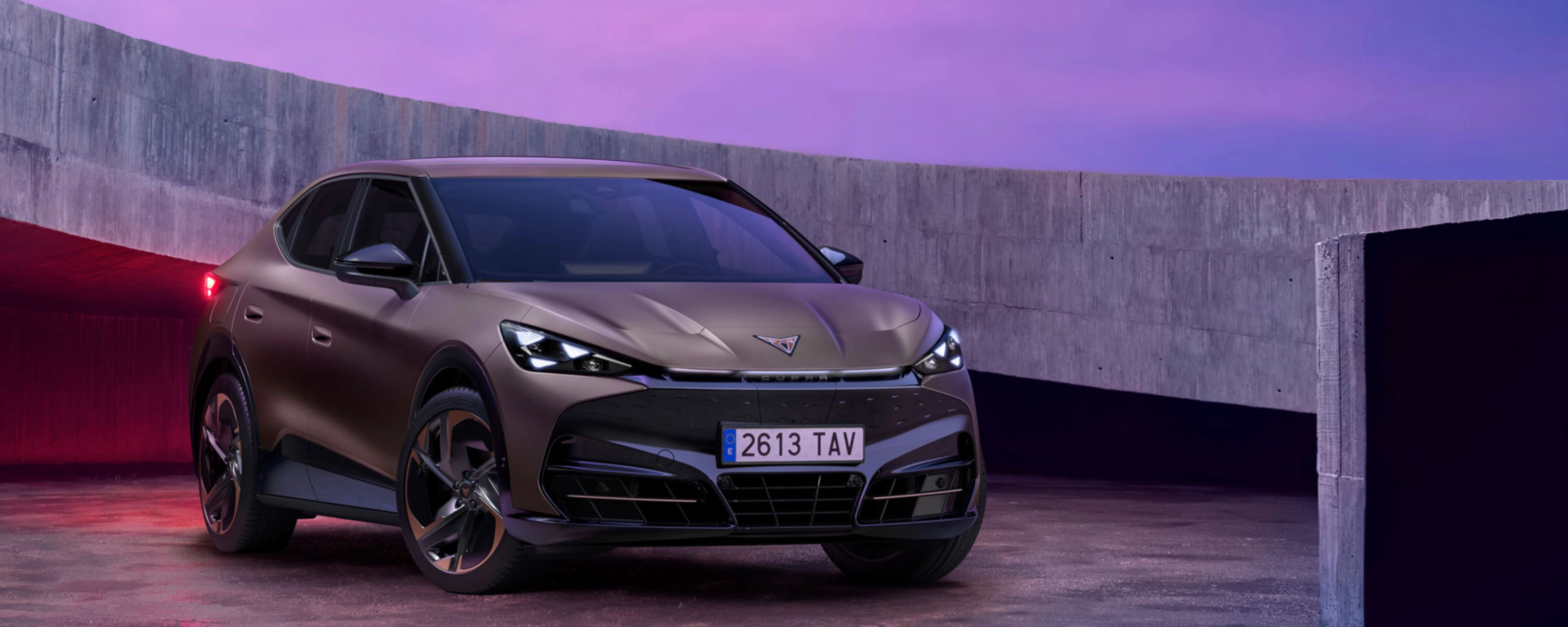 Cupra car parked in modern concrete setting with purple lighting.