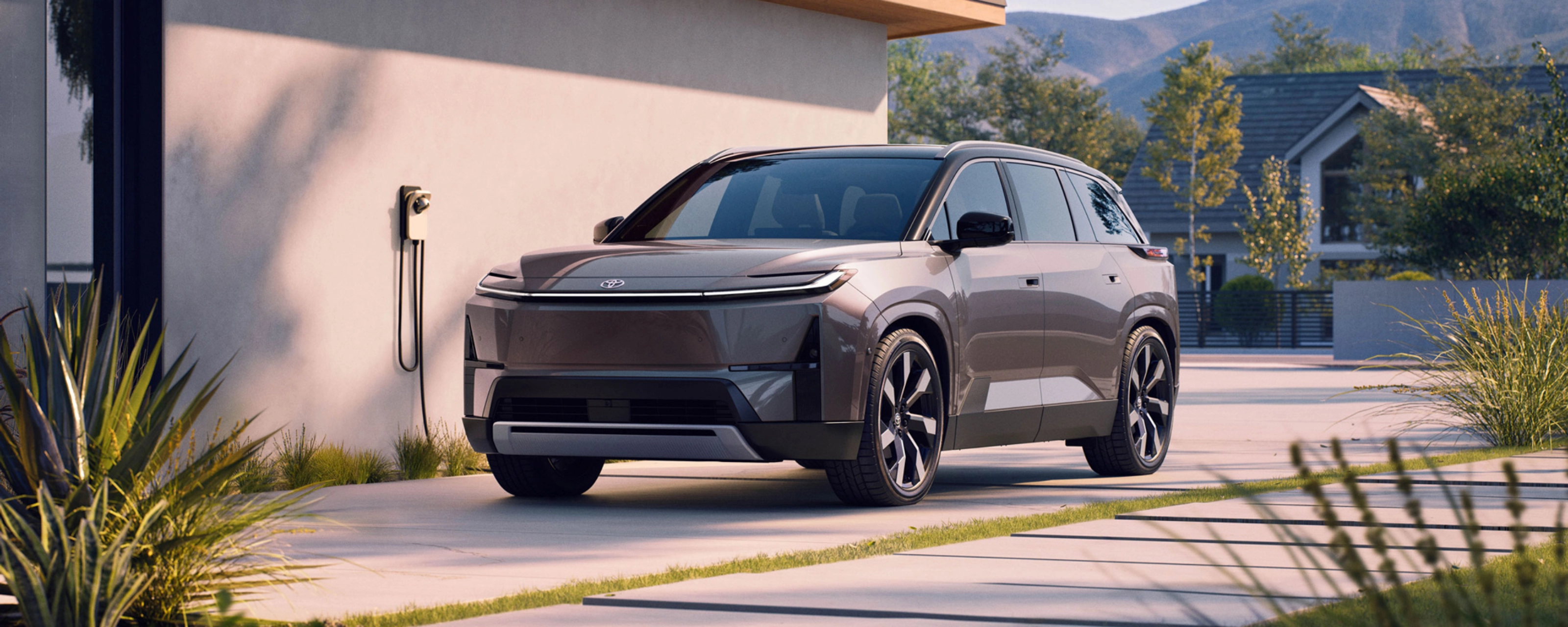 Electric SUV parked at home charging station.