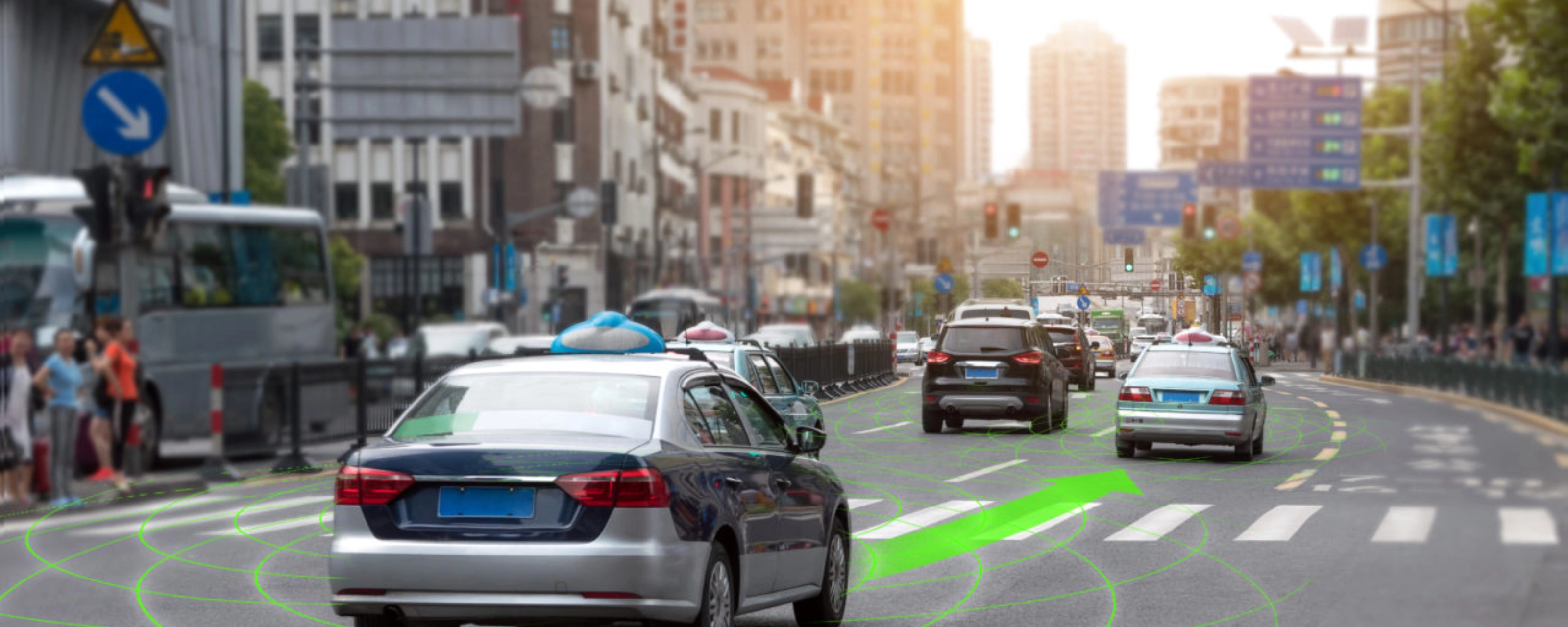 Car driving through a city street with lane guidance highlighted by driver assistance.