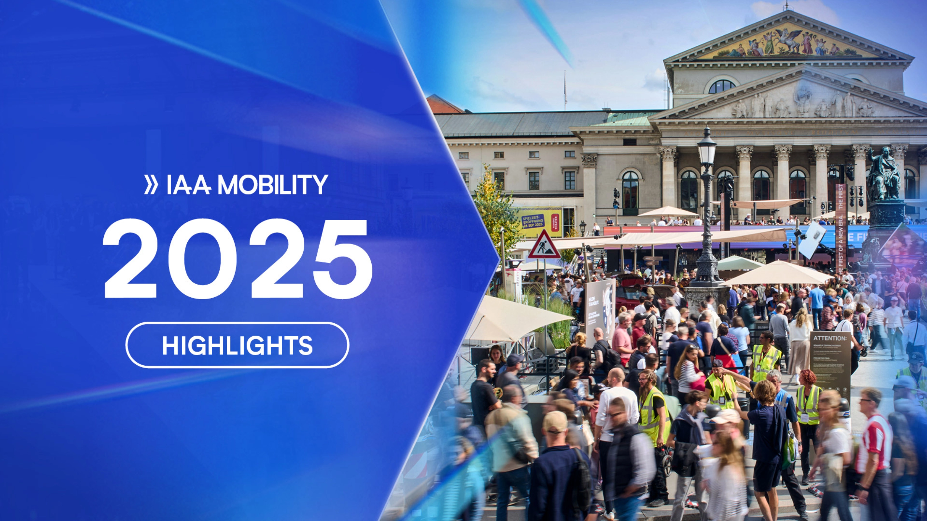 Crowds visit the IAA Mobility 2025 outdoor exhibition in front of a historic building in Munich.