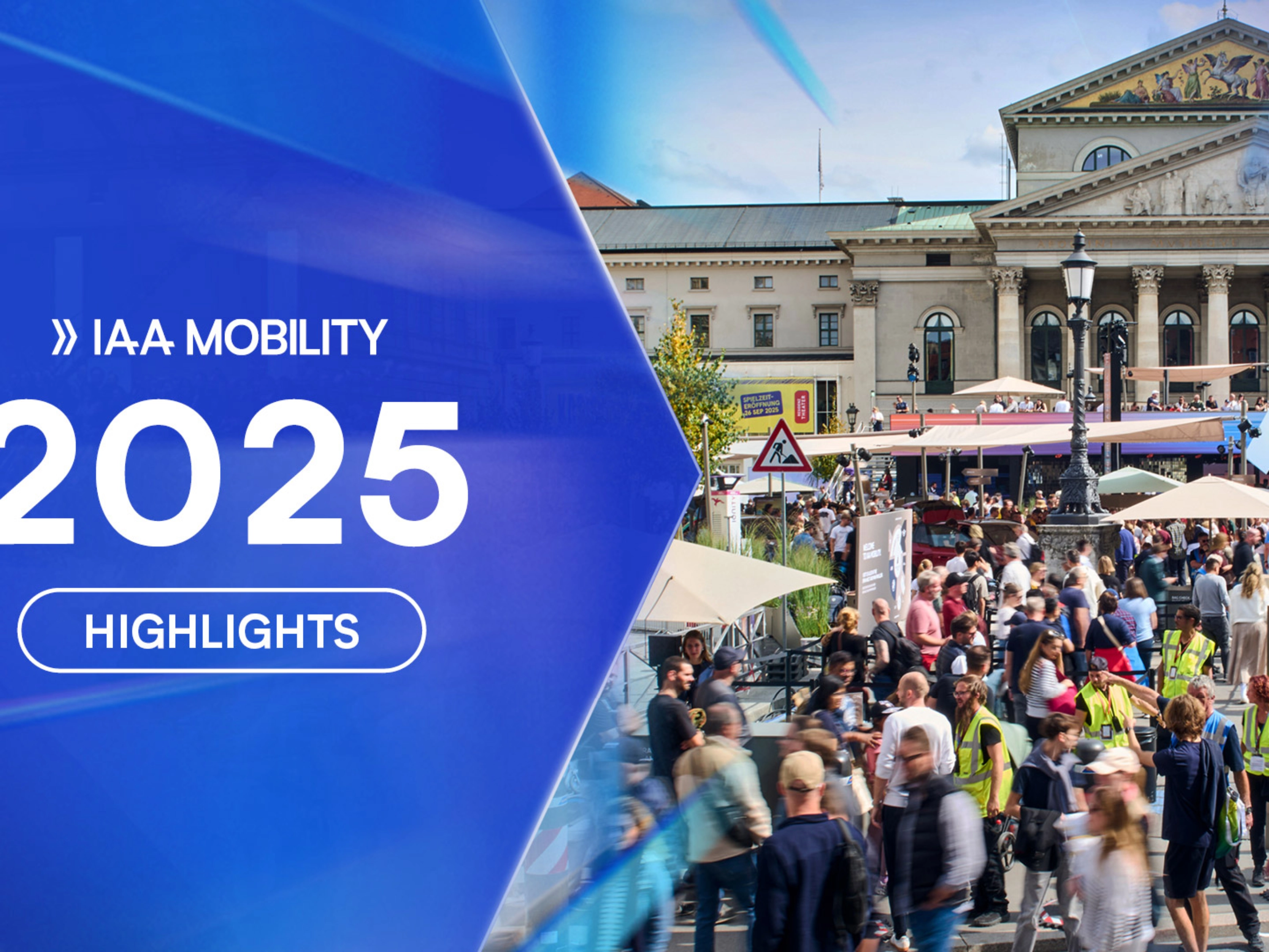 Crowds visit the IAA Mobility 2025 outdoor exhibition in front of a historic building in Munich.