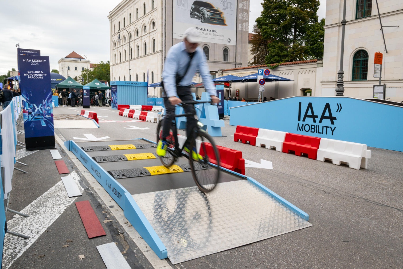 Cyclist rides over an obstacle course at the IAA Mobility exhibition.