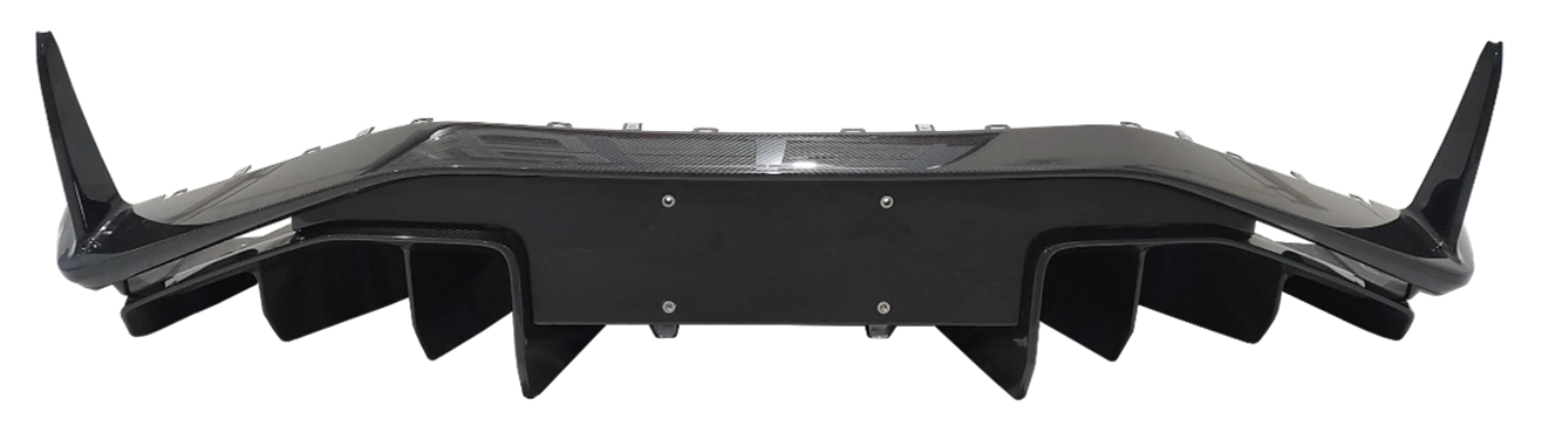 Carbon fiber rear diffuser with vertical fins and aerodynamic side elements.