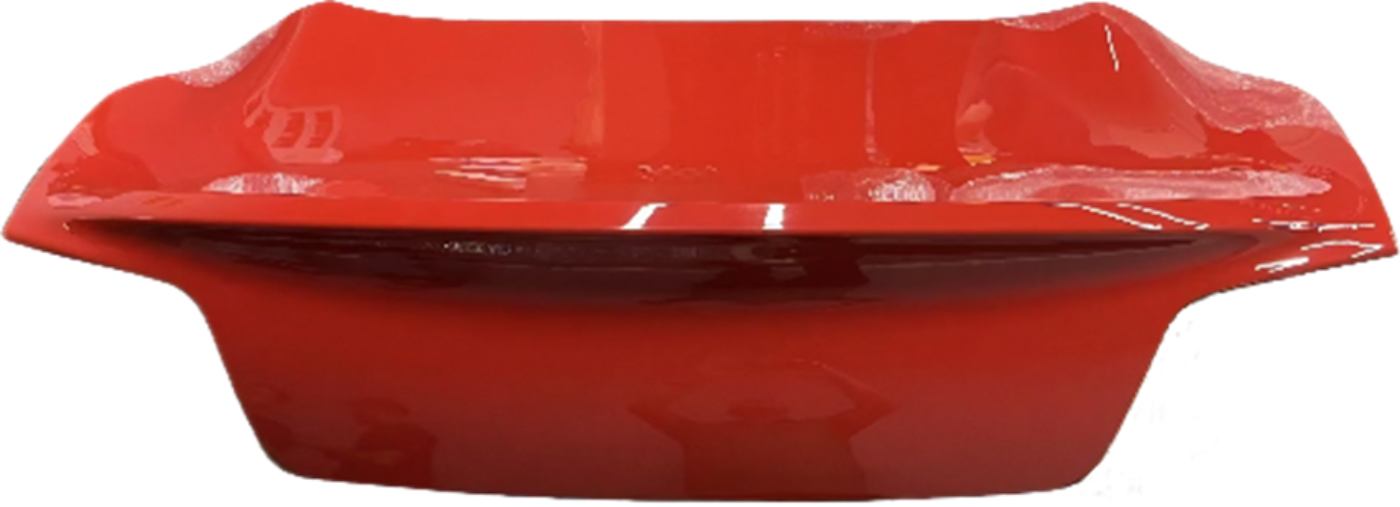 Glossy red automotive body panel with aerodynamic shape and curved edges.
