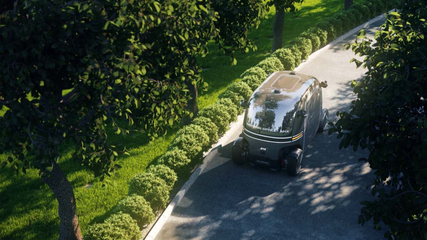 Autonomer Mini-Bus fährt auf einem sonnigen, baumbestandenen Weg durch einen grünen Park.