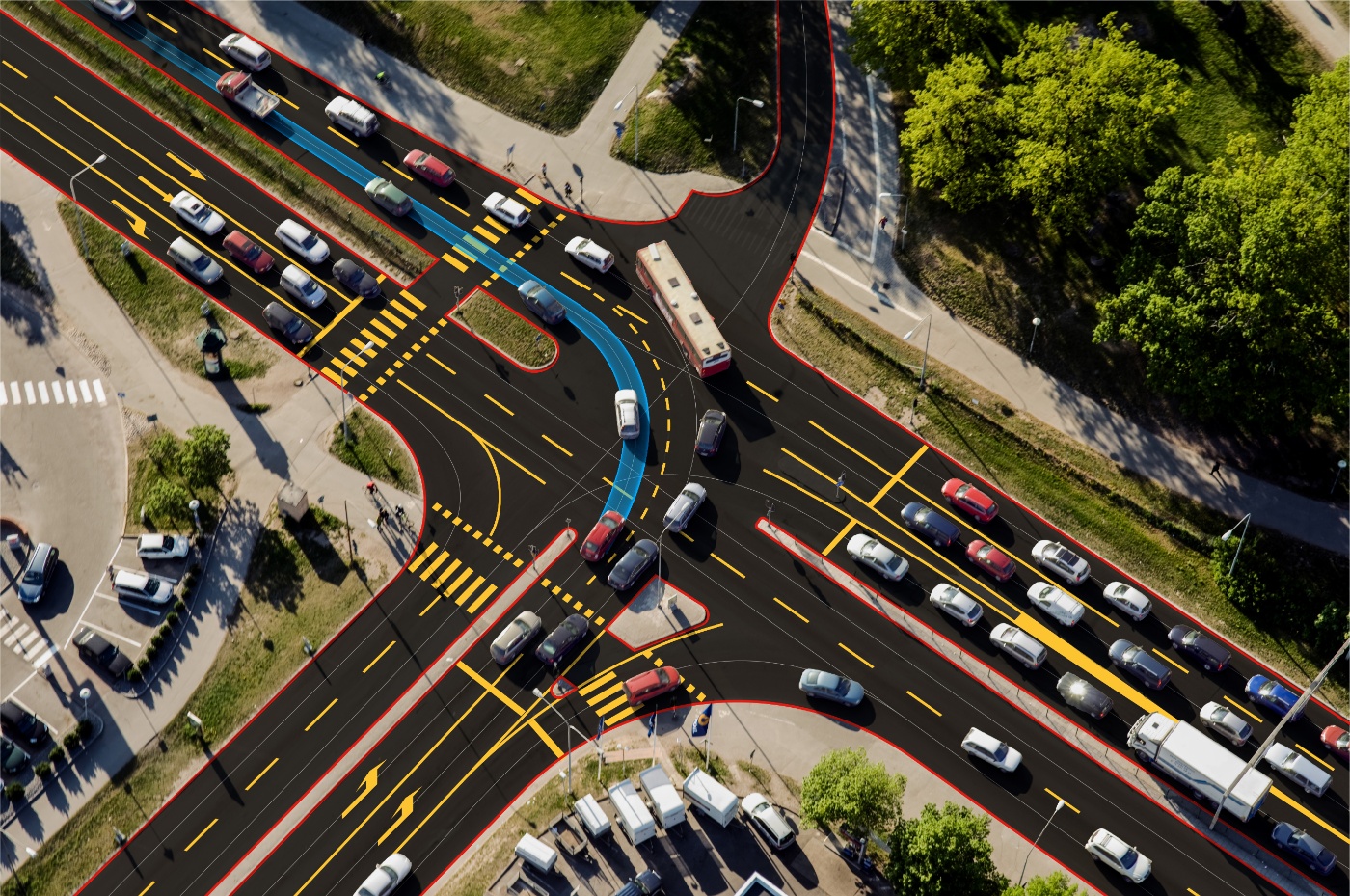 Kreuzung mit mehreren Fahrspuren, hohem Verkehrsaufkommen und markierten Fahrtrouten.