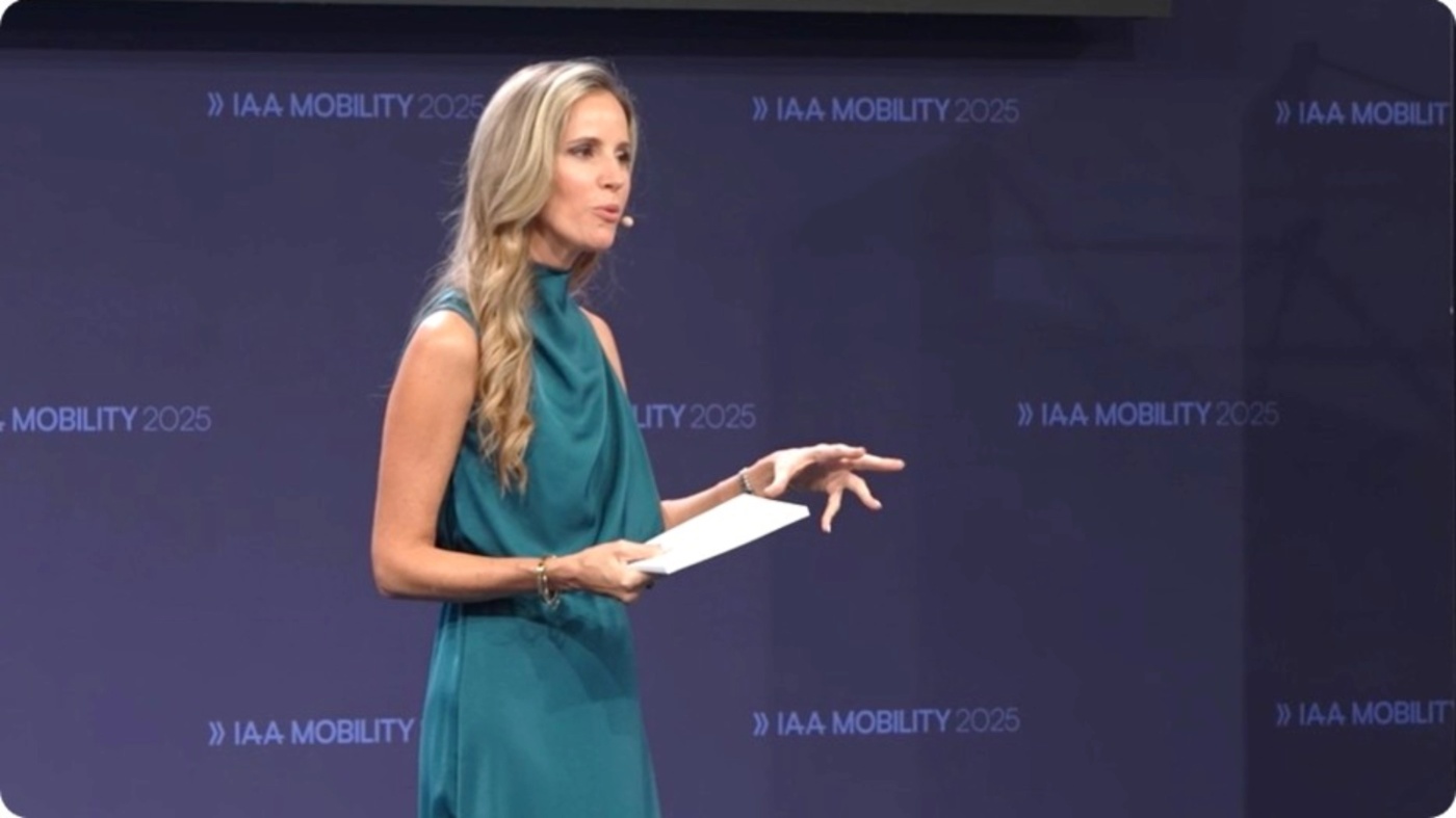 Speaker giving a presentation on stage at a mobility conference.