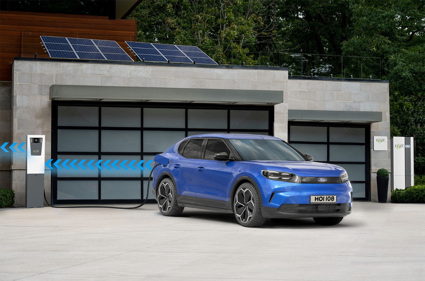 A blue electric SUV is parked in front of a modern building with solar panels, connected to a charging station with visual arrows indicating energy flow.