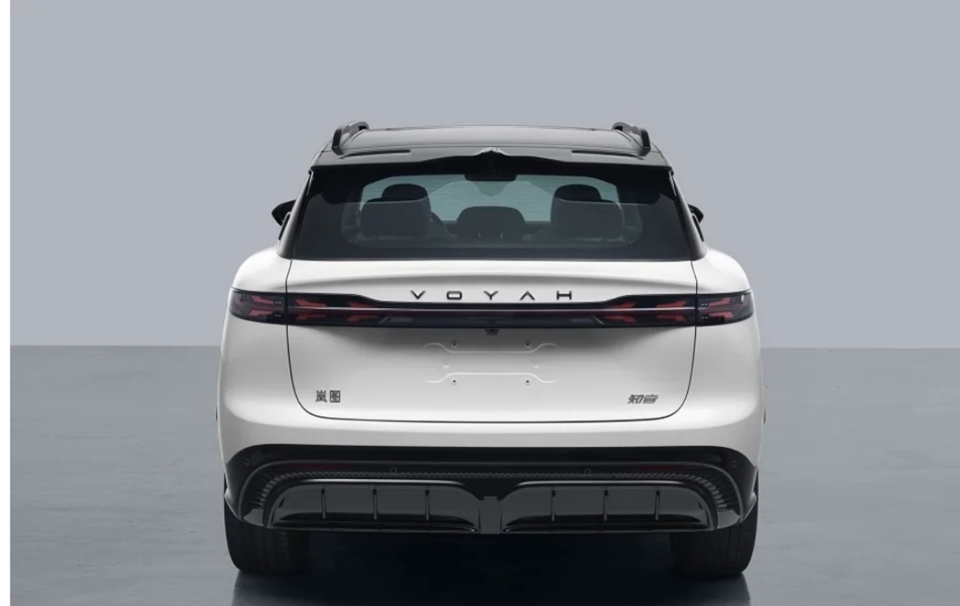 Rear view of a white Voyah electric SUV with a black roof and slim horizontal taillights, parked in a studio.