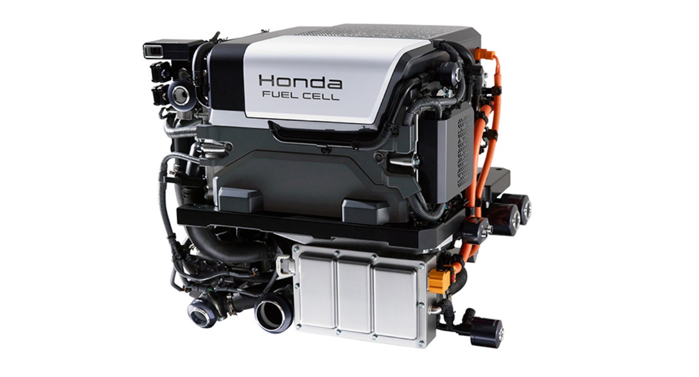 Compact hydrogen fuel cell system by Honda with visible wiring and labeled components, displayed in a studio setting.