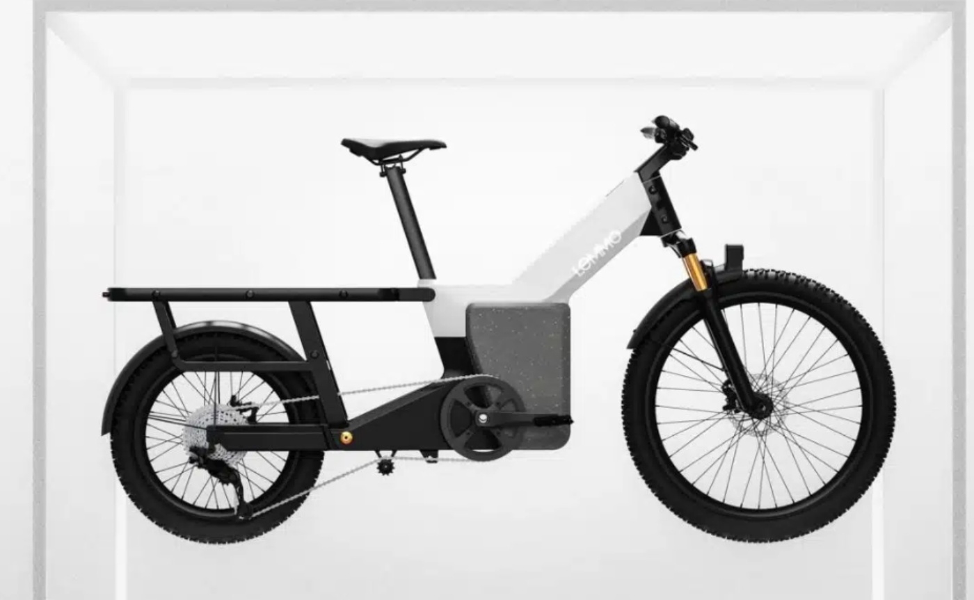Modern electric cargo bike with a minimalist frame, shown in a white display setting.