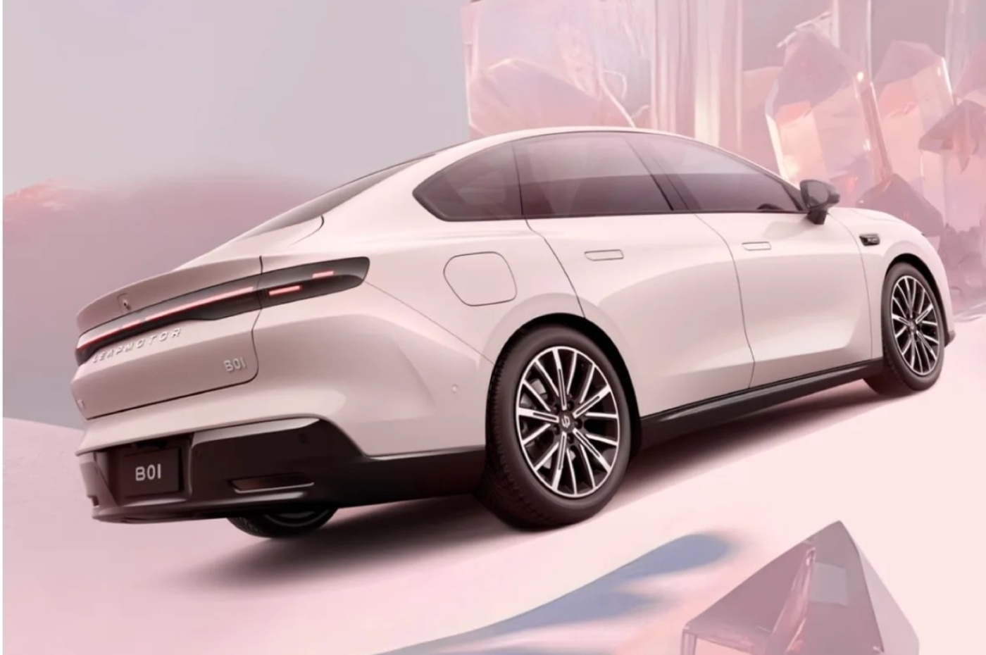 A sleek white electric sedan, viewed from the rear side, is displayed in a pastel-colored environment with abstract shapes in the background.