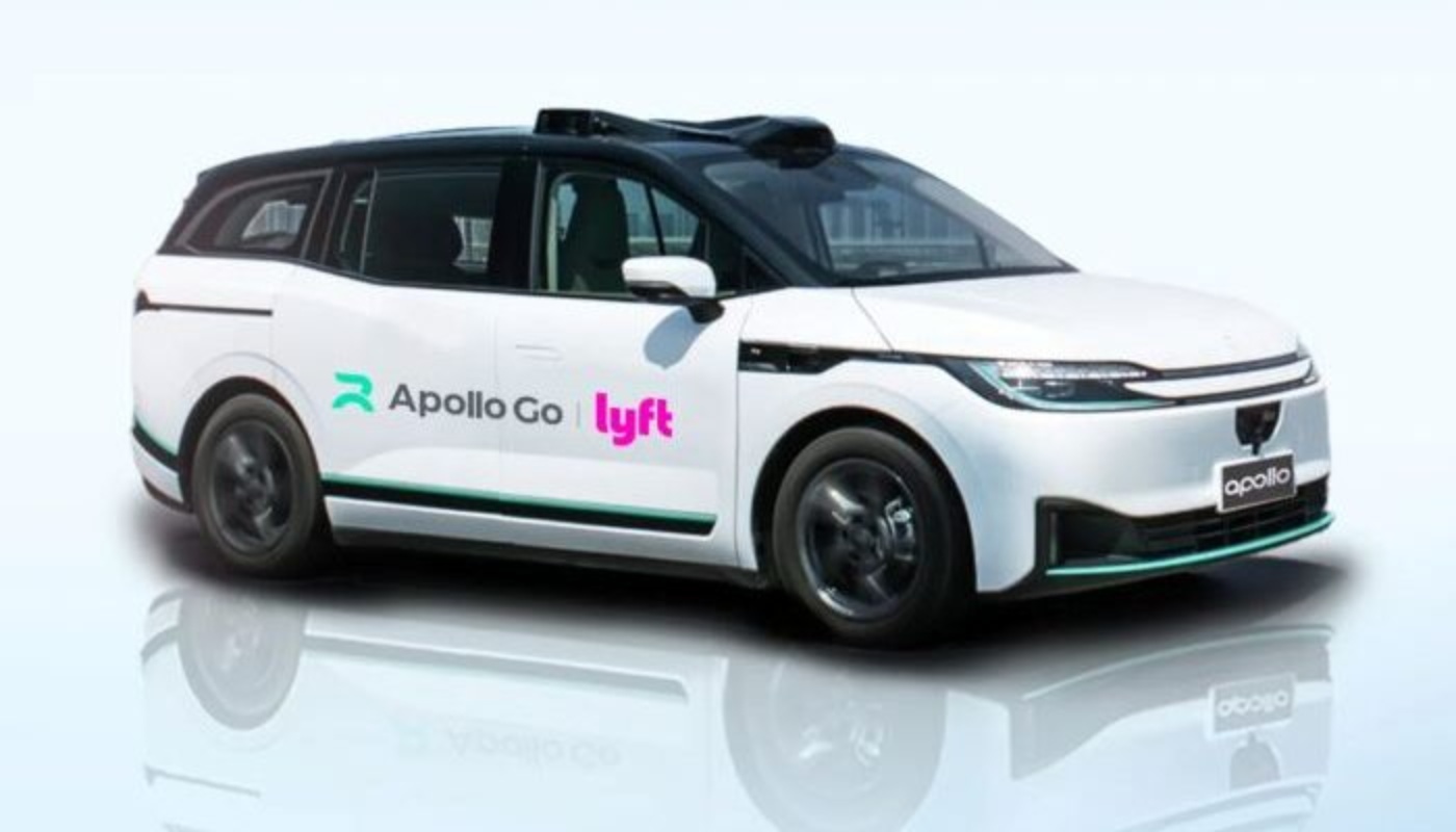 White autonomous ride-hailing car with Apollo Go and Lyft logos.