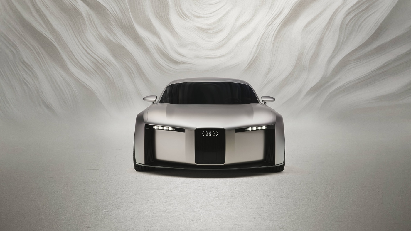 Frontansicht eines futuristischen Audi-Konzeptautos vor hellem, abstraktem Hintergrund.