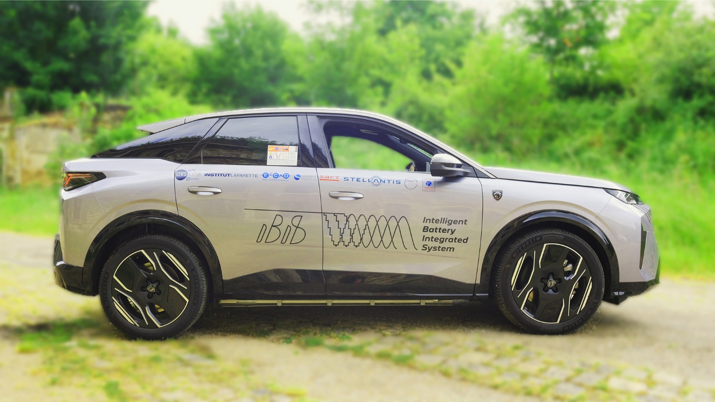 Electric test vehicle with Intelligent Battery Integrated System branding parked outdoors.