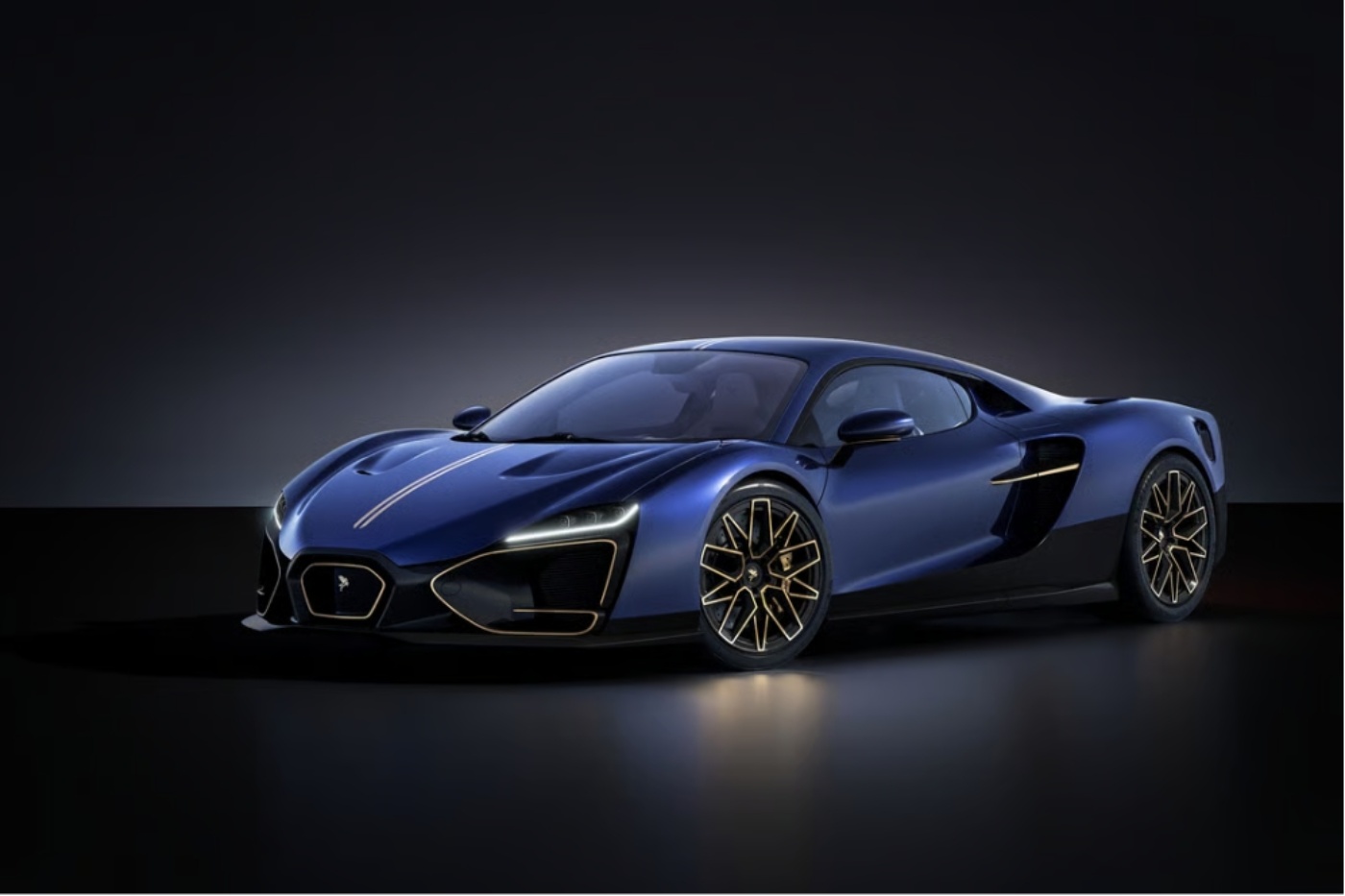 Dark blue sports car with gold accents shown in a studio setting with black background.