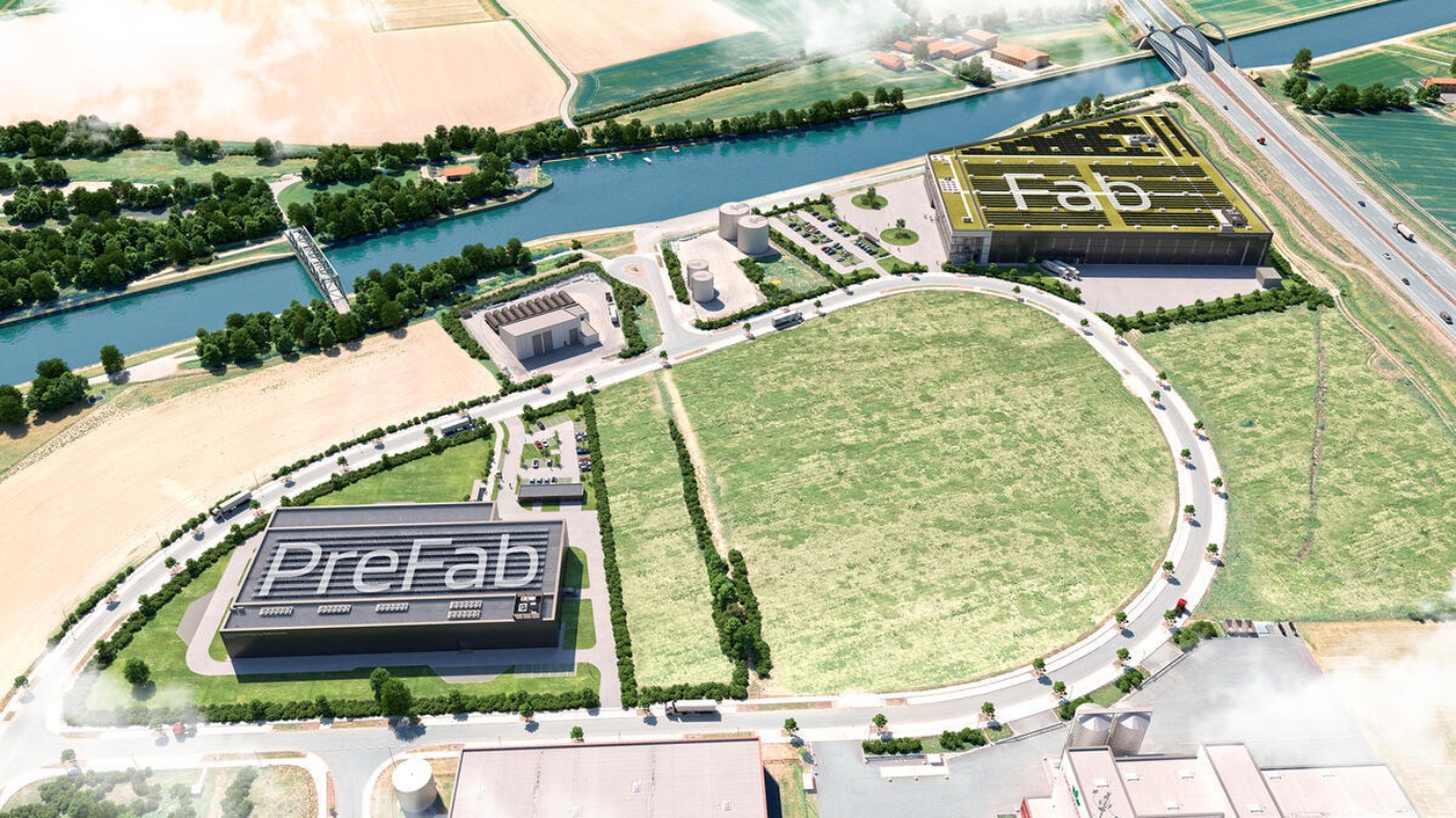 Aerial view of an industrial site with two large factory buildings labeled "PreFab" and "Fab".