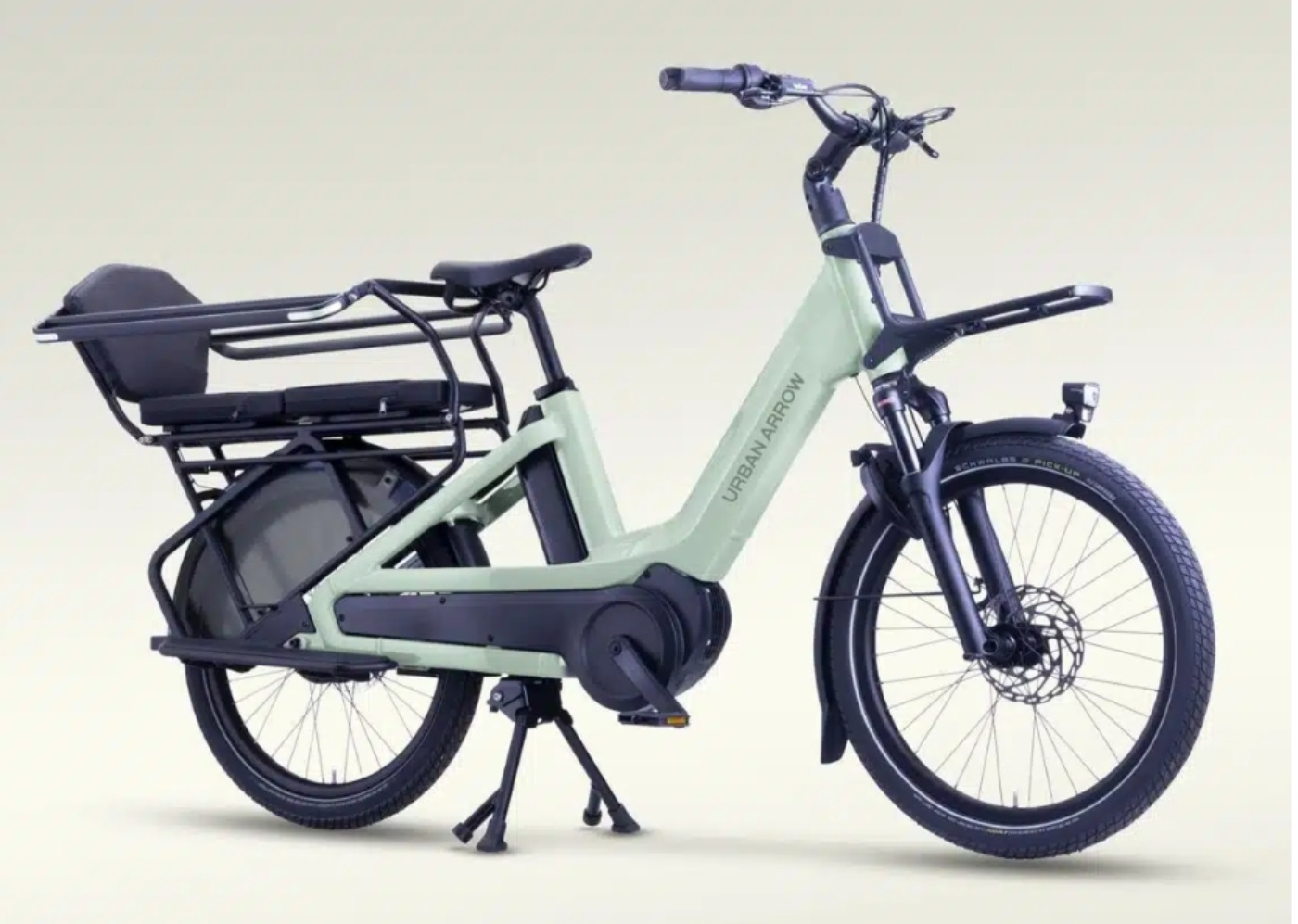 Electric cargo bike with padded rear seat and sturdy frame, shown from the side.