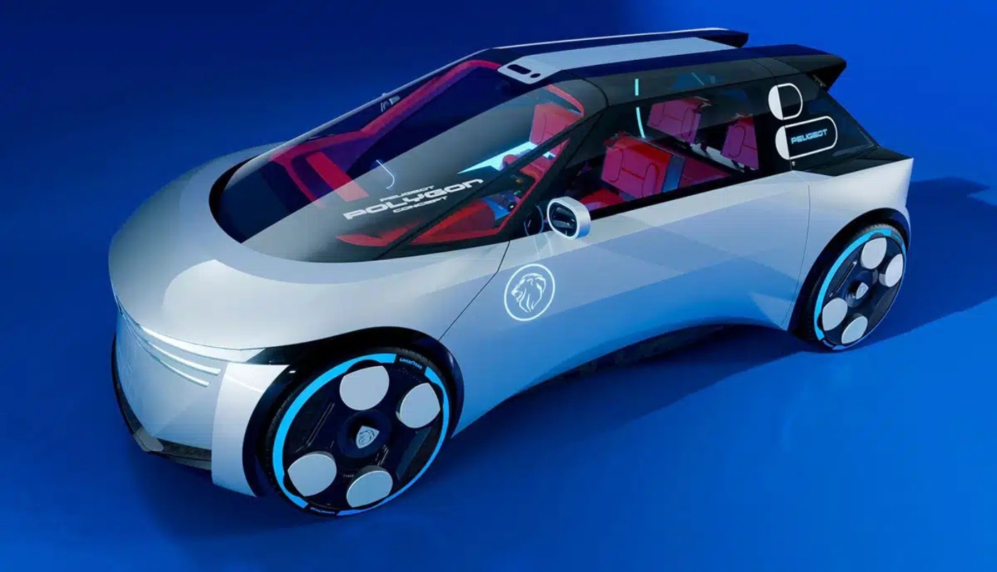 Silver Peugeot Polygon compact car with large glass front, black roof, and red seats on blue background.