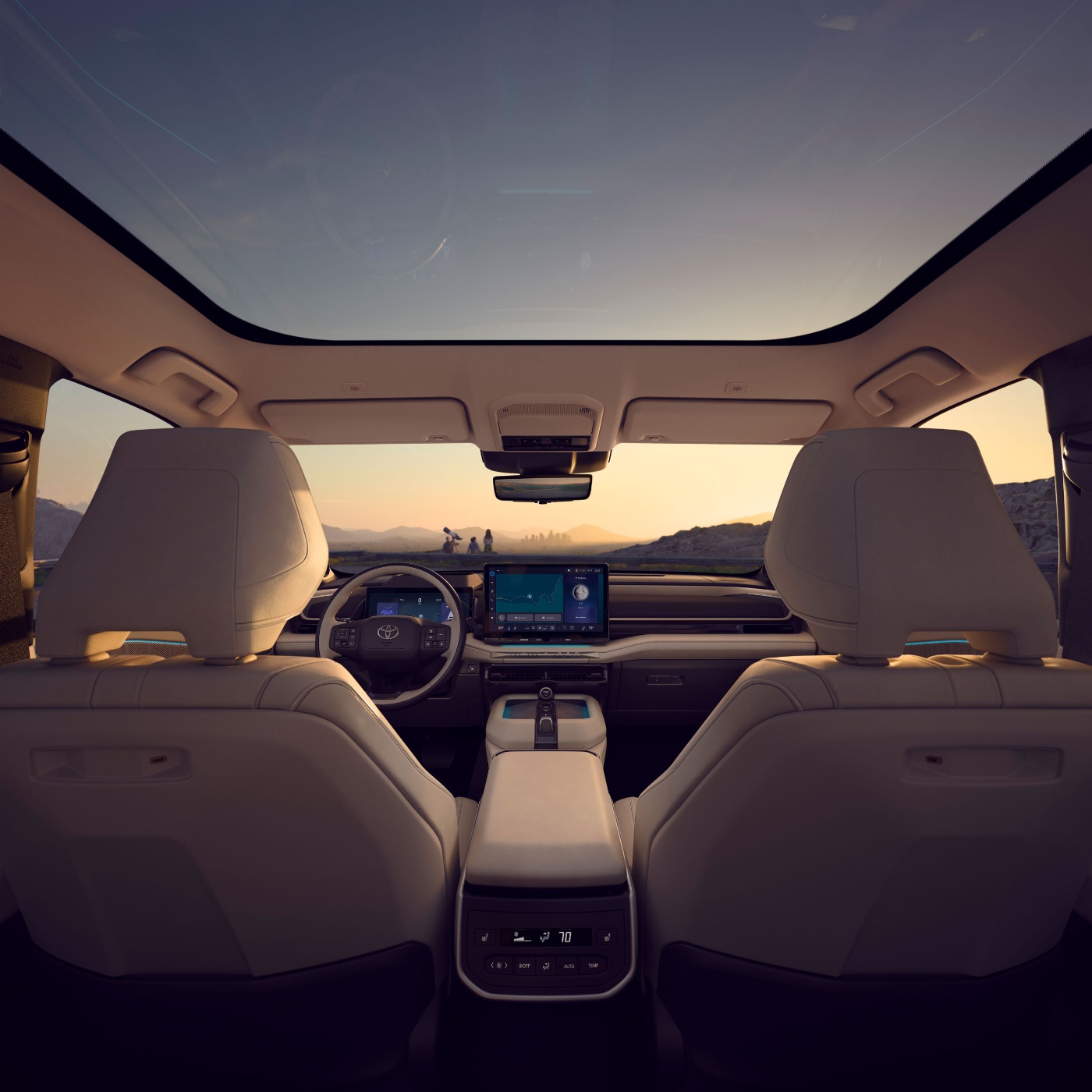 Car interior with panoramic roof and sunset view.