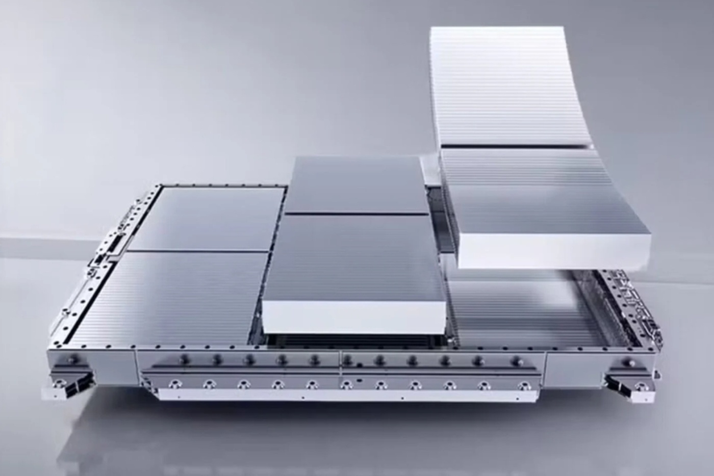 Stacked battery modules on a metal platform, with one module lifted above the others.