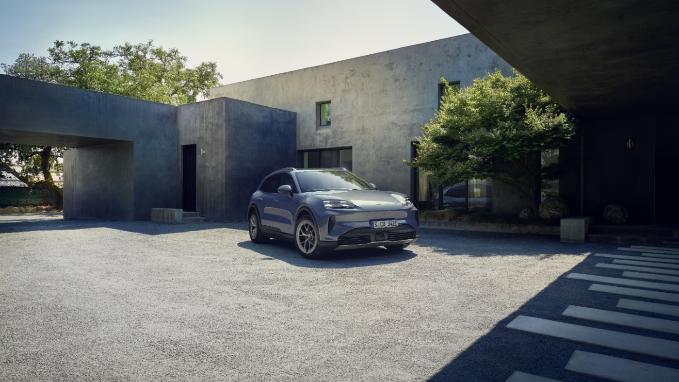 Porsche Cayenne S parked in front of a modern house.