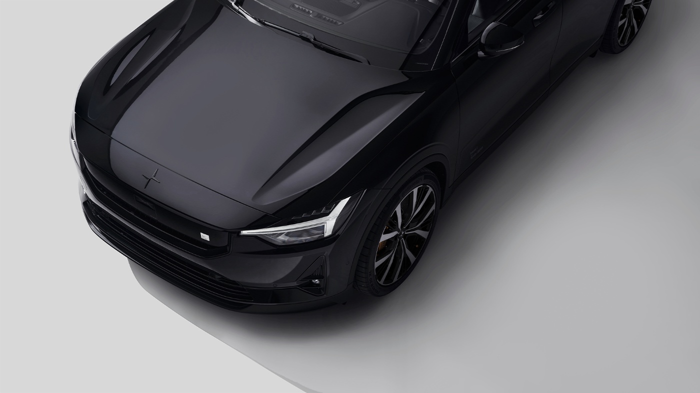 Top view of a black Polestar car on a neutral background.