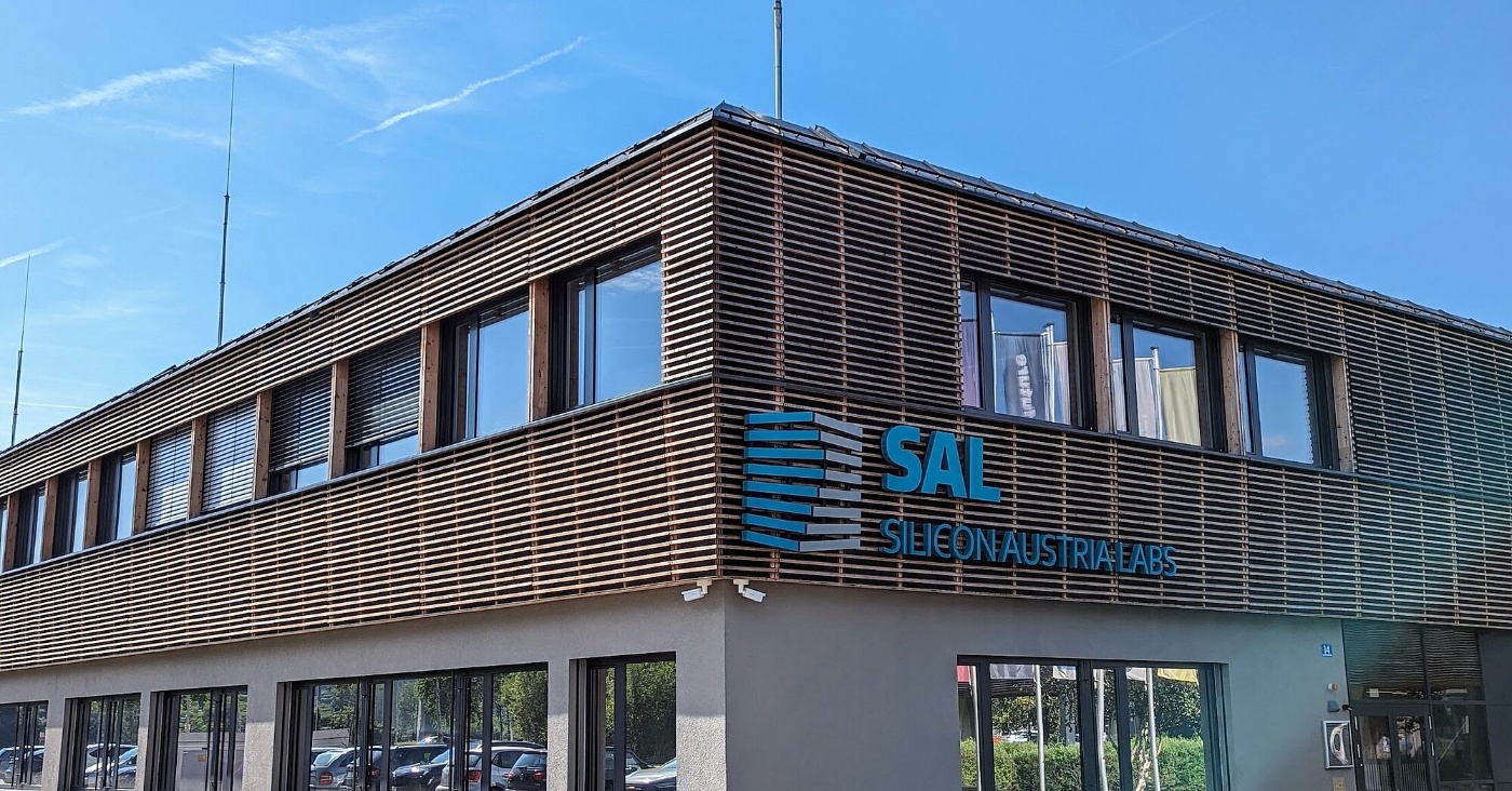 Modern building facade with SAL Silicon Austria Labs logo.