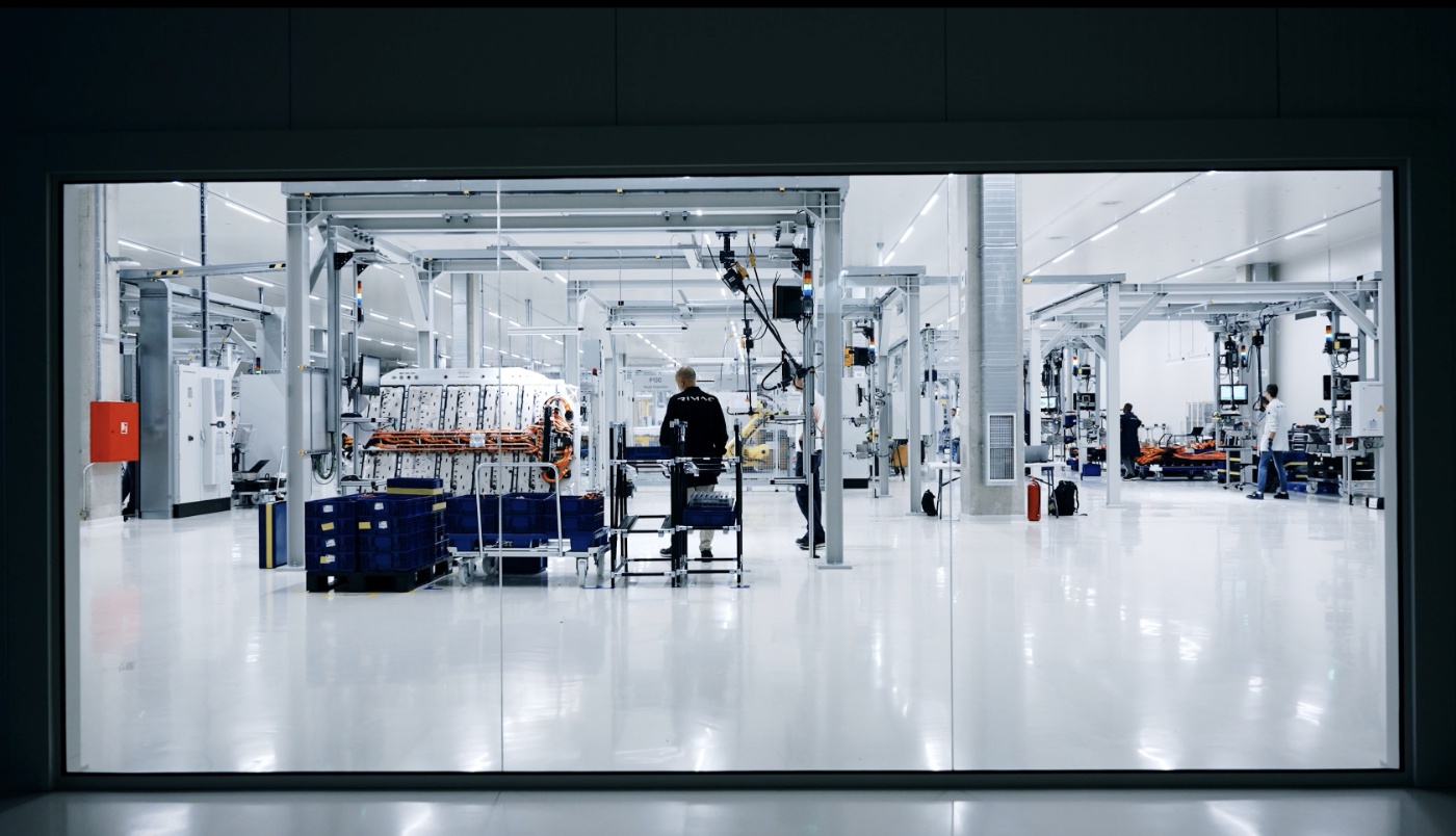 Wide view of a modern factory hall with automated production lines and workstations.