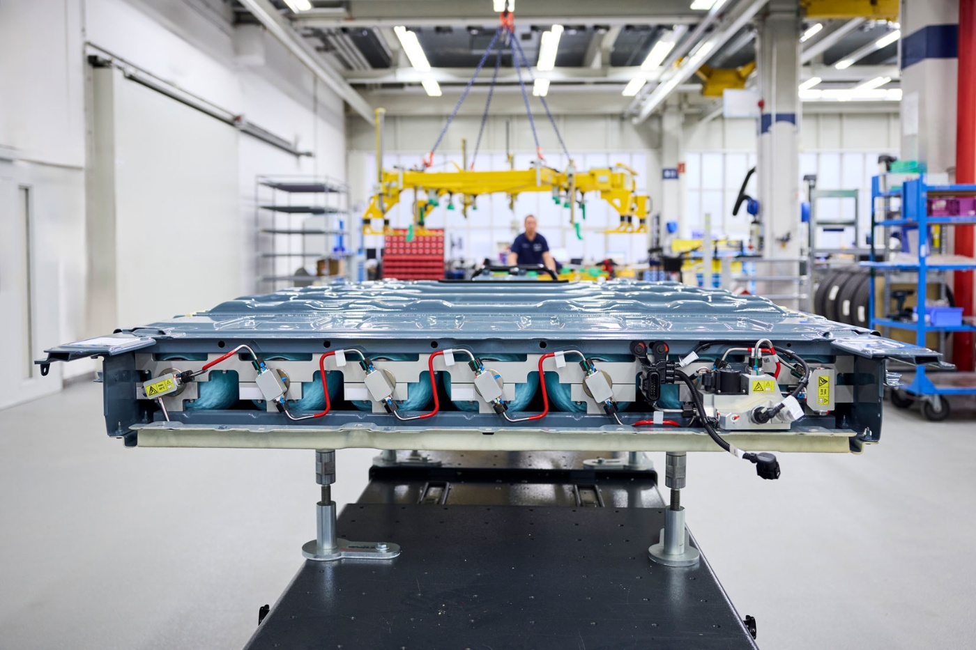 BMW vehicle body platform mounted on an automated assembly fixture in a factory hall.